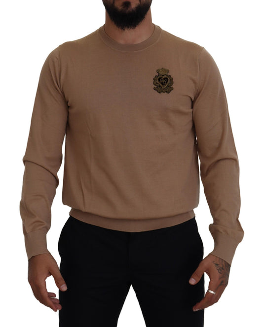 Man wearing brown sweater with emblem on left chest