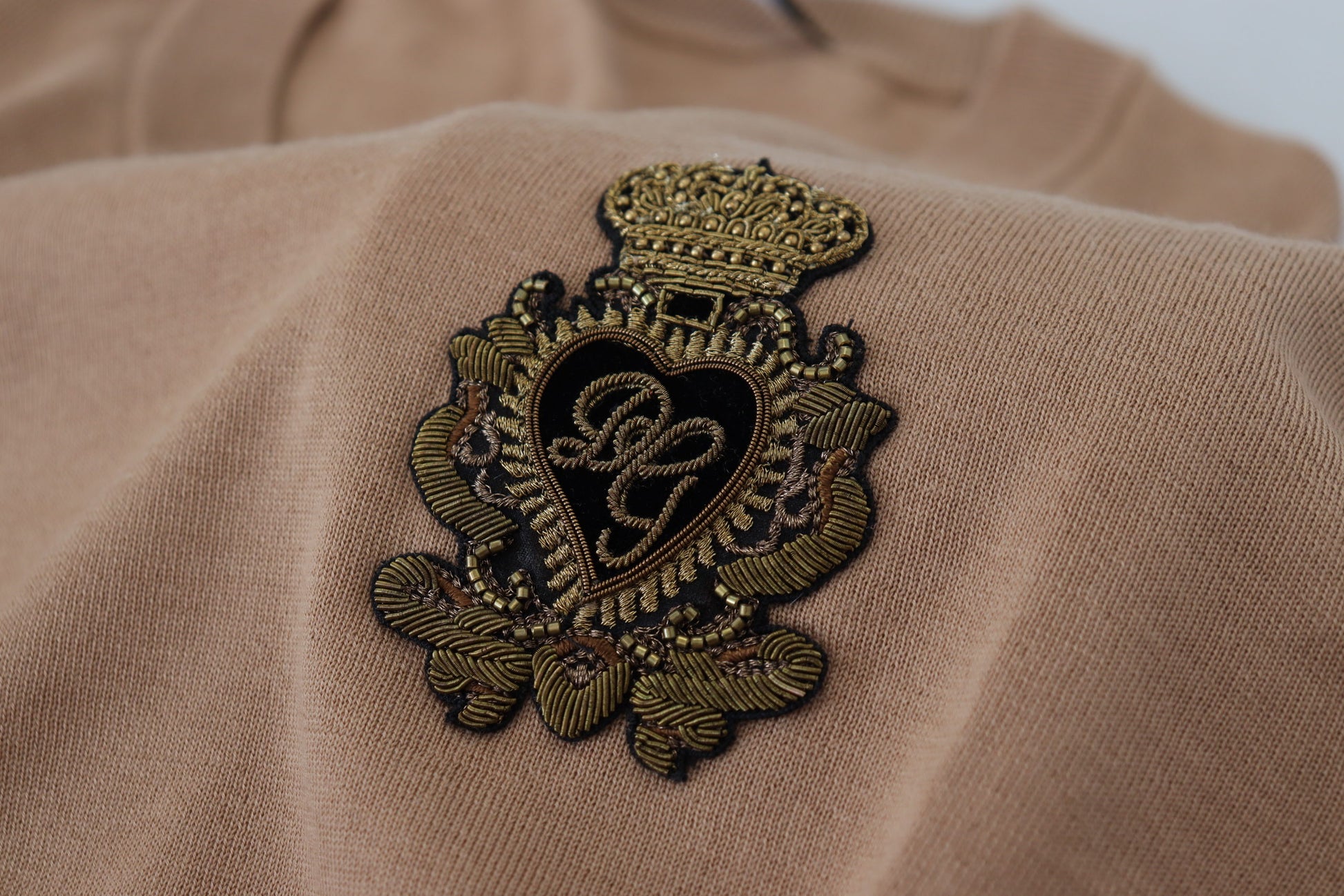 Embellished heart on a beige garment
