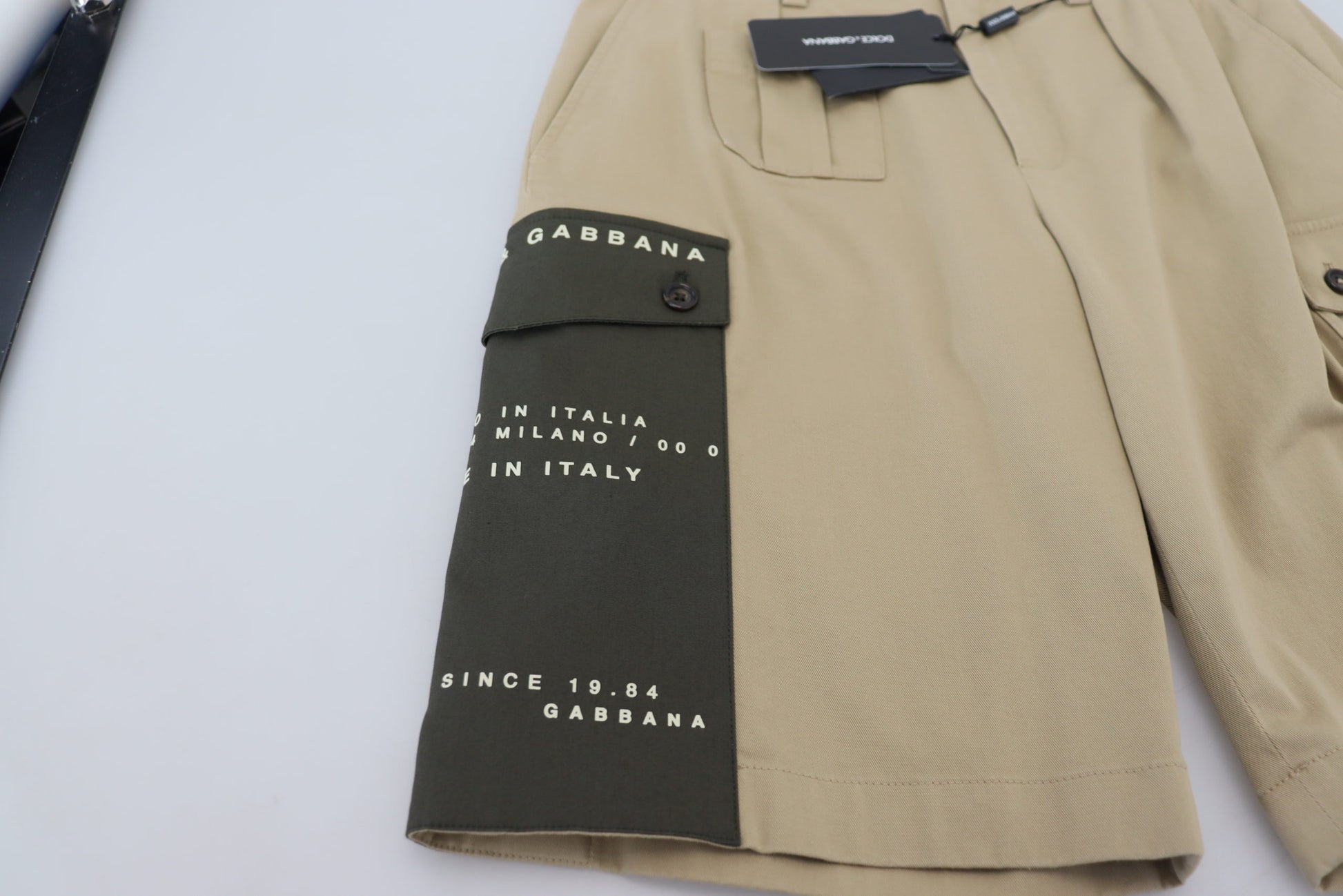 Tan jacket with green patch on sleeve