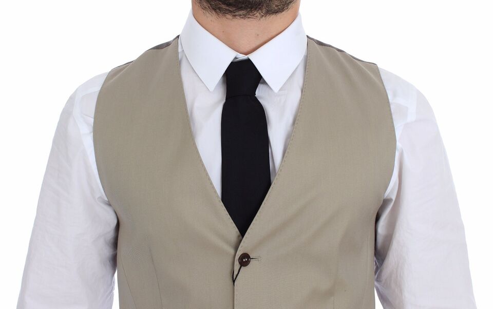 A beige cotton vest jacket with a black tie, part of the Dolce & Gabbana collection