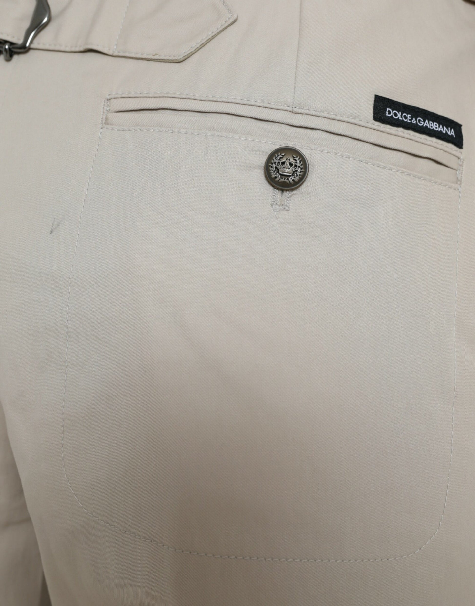 Tan pants with black button and label on front