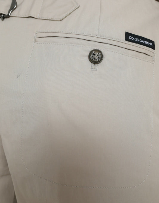Tan pants with black button and label on front