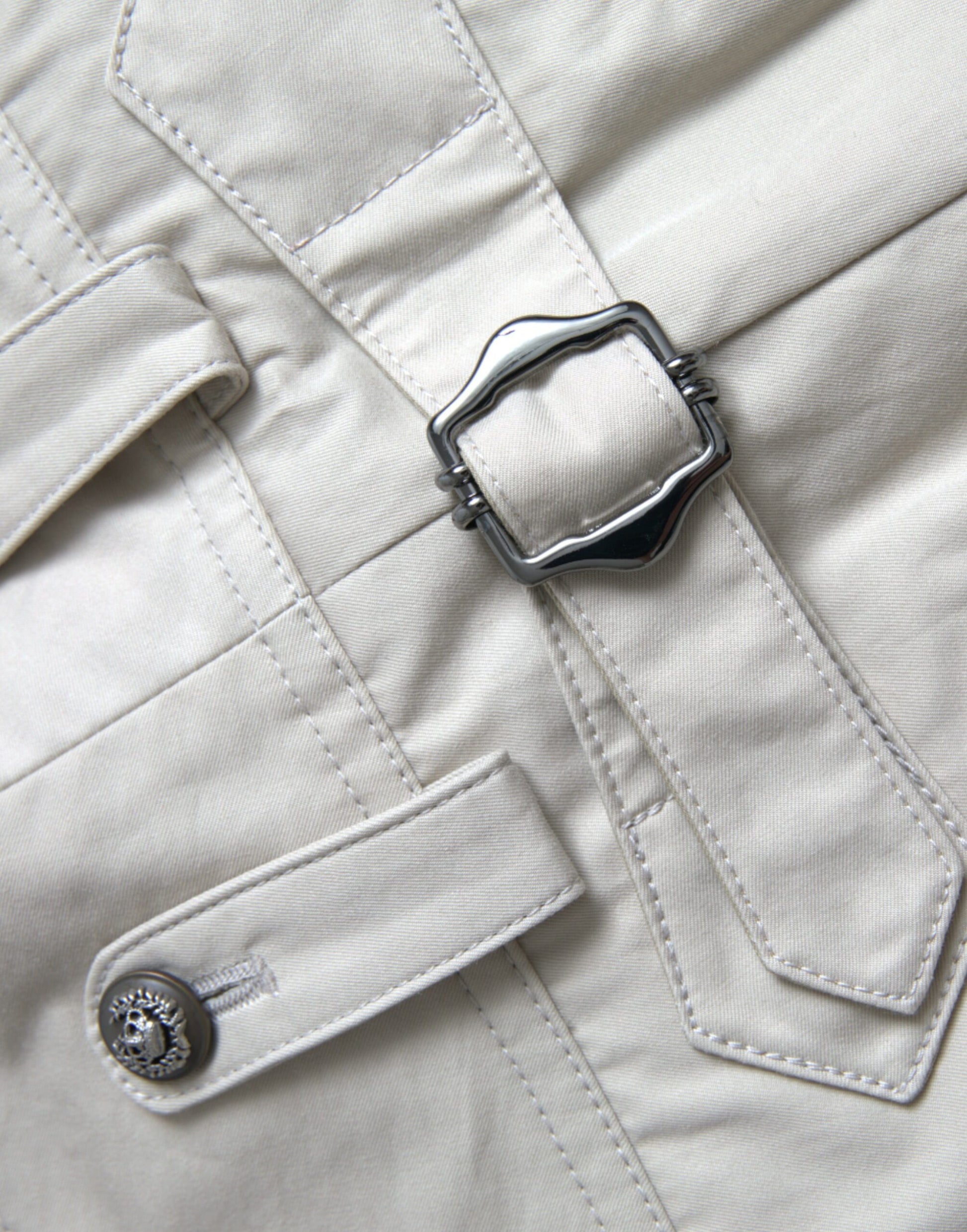Pocket on a beige jacket with a silver button