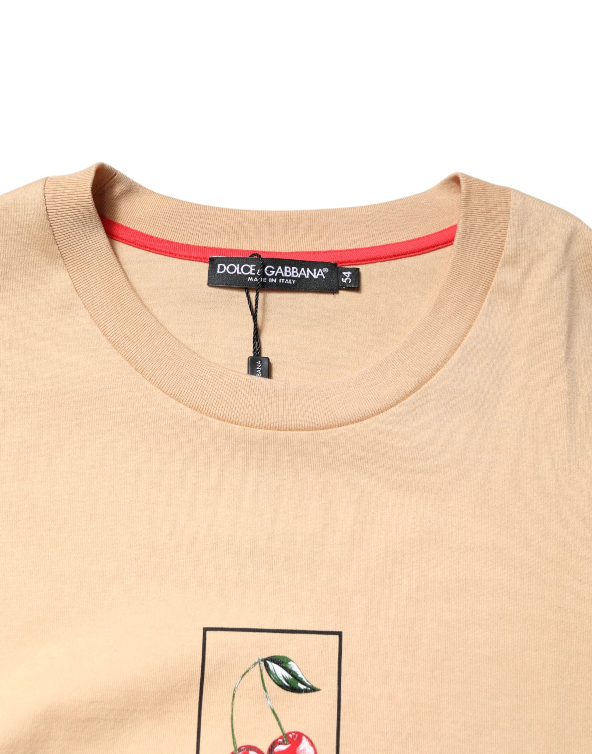 Tan sweater with red trim and embroidered cherry blossom on front