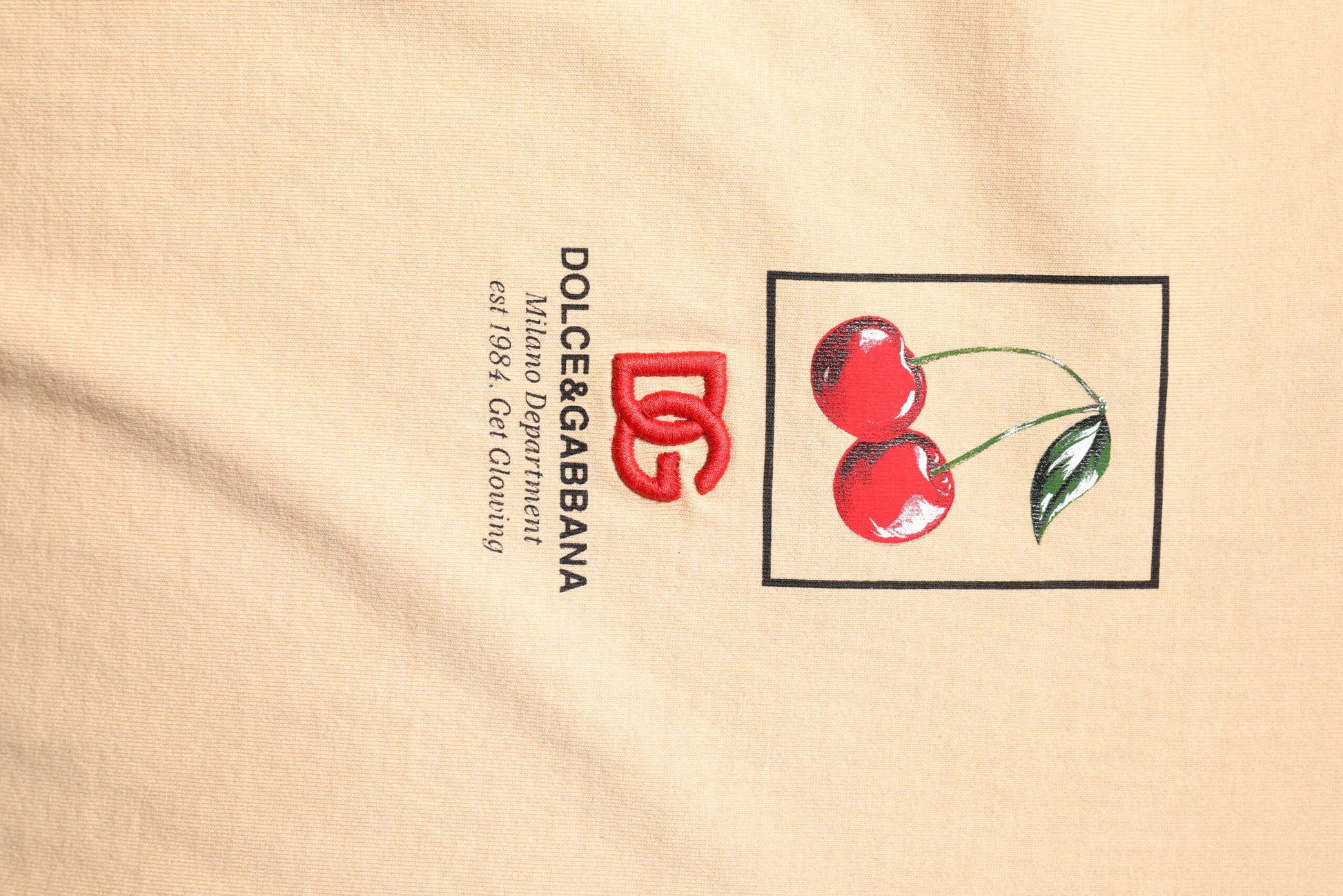 Cherry embroidered logo on fabric