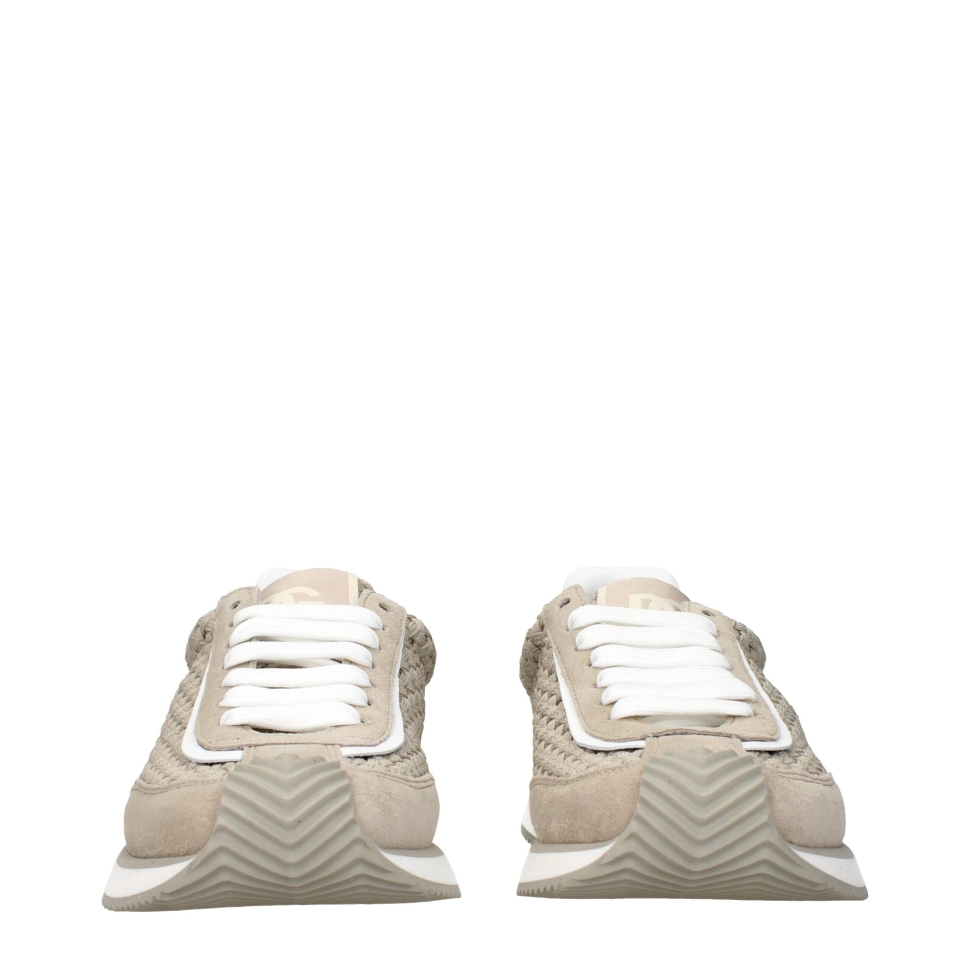 Pair of beige fabric low top sneakers with white laces and a textured sole