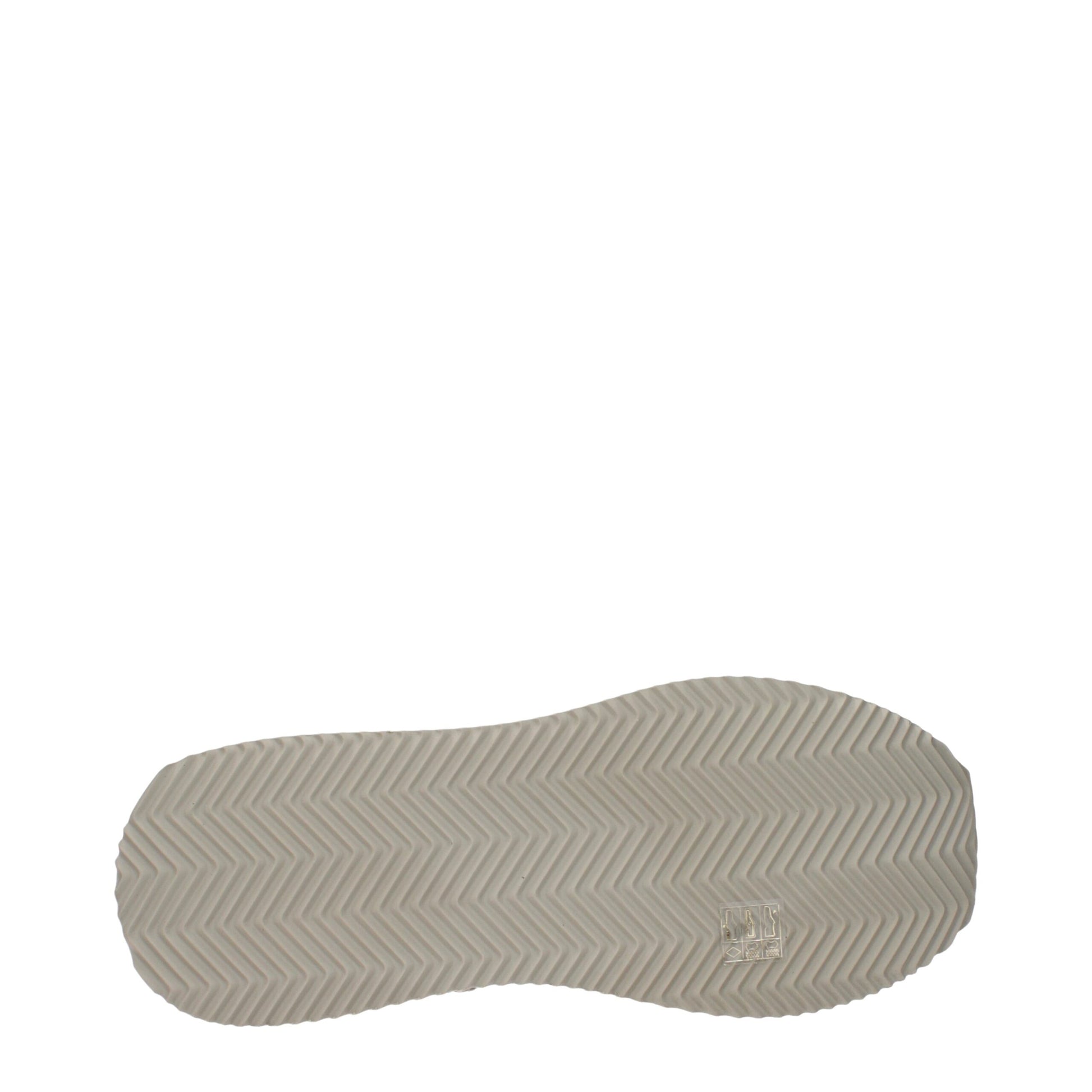 A single beige fabric shoe with a textured sole, featuring a low top design and the brand logo on the side
