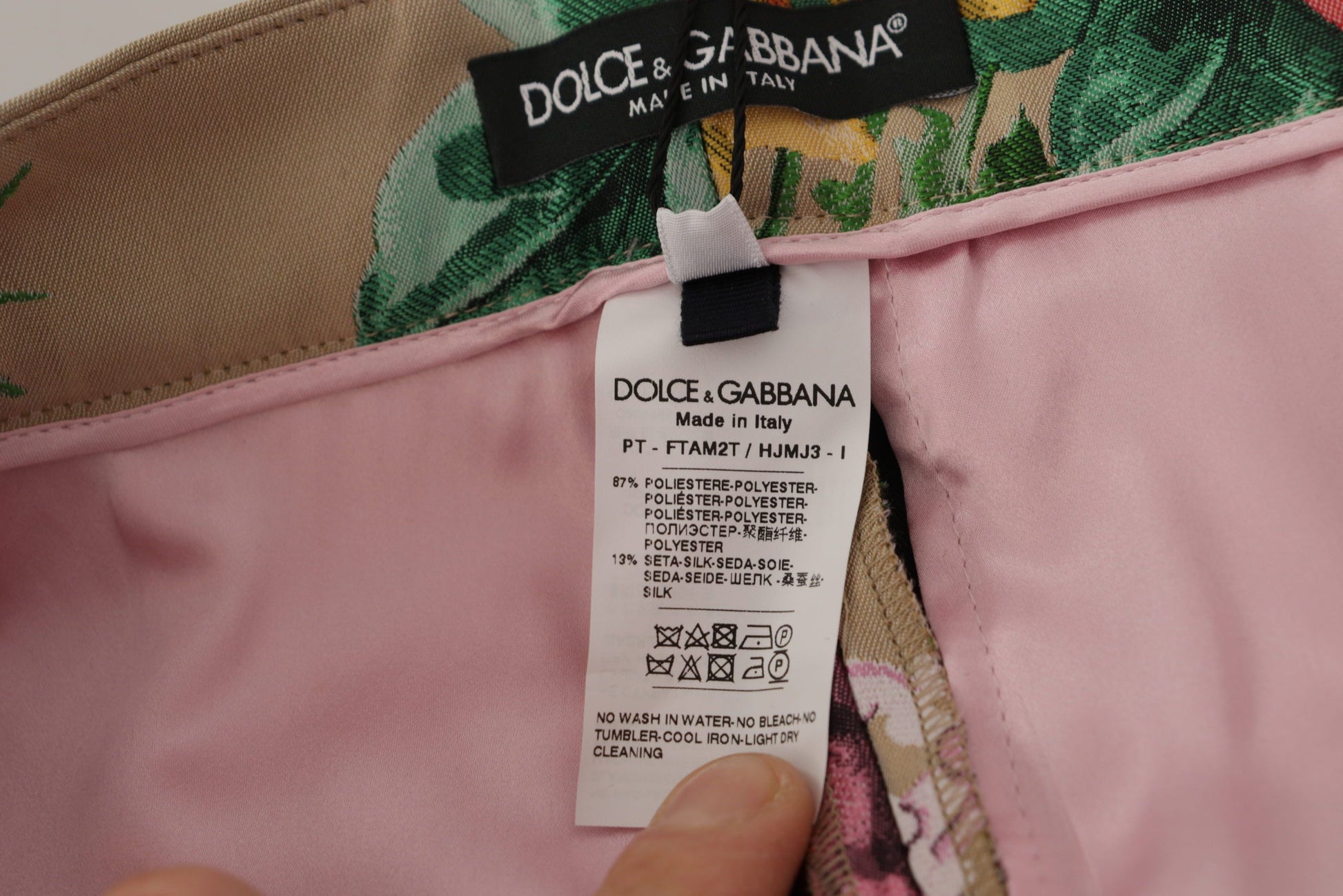 A pair of high waist beige floral formal pants by Dolce & Gabbana