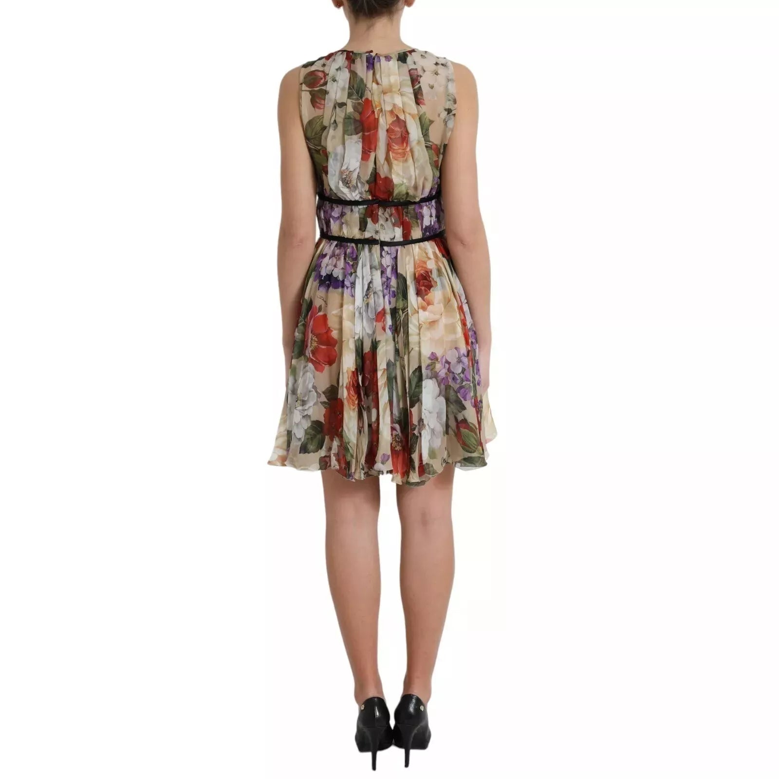 A beige floral sleeveless mini dress with an A-line silhouette