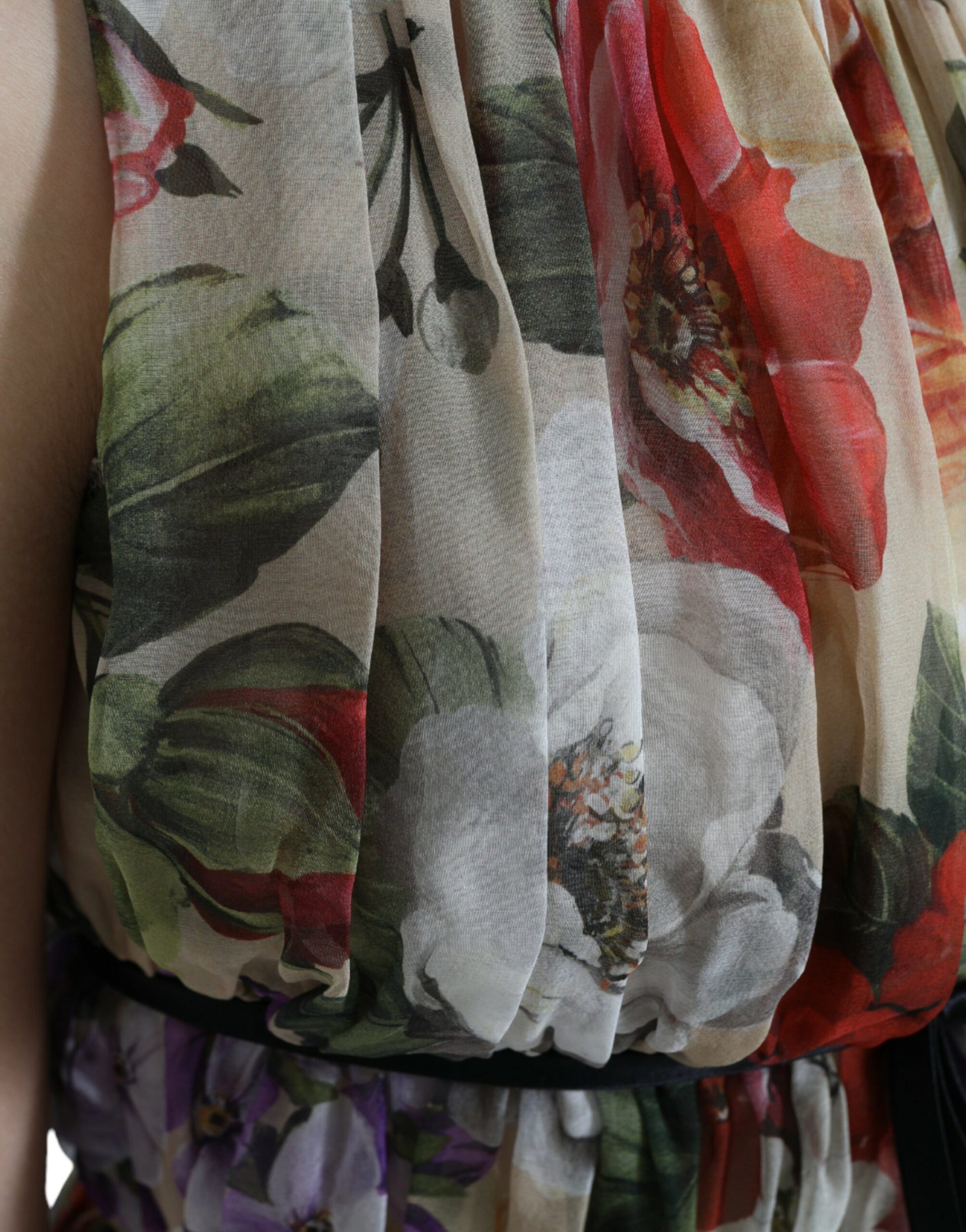 A beige floral sleeveless dress with an A-line silhouette