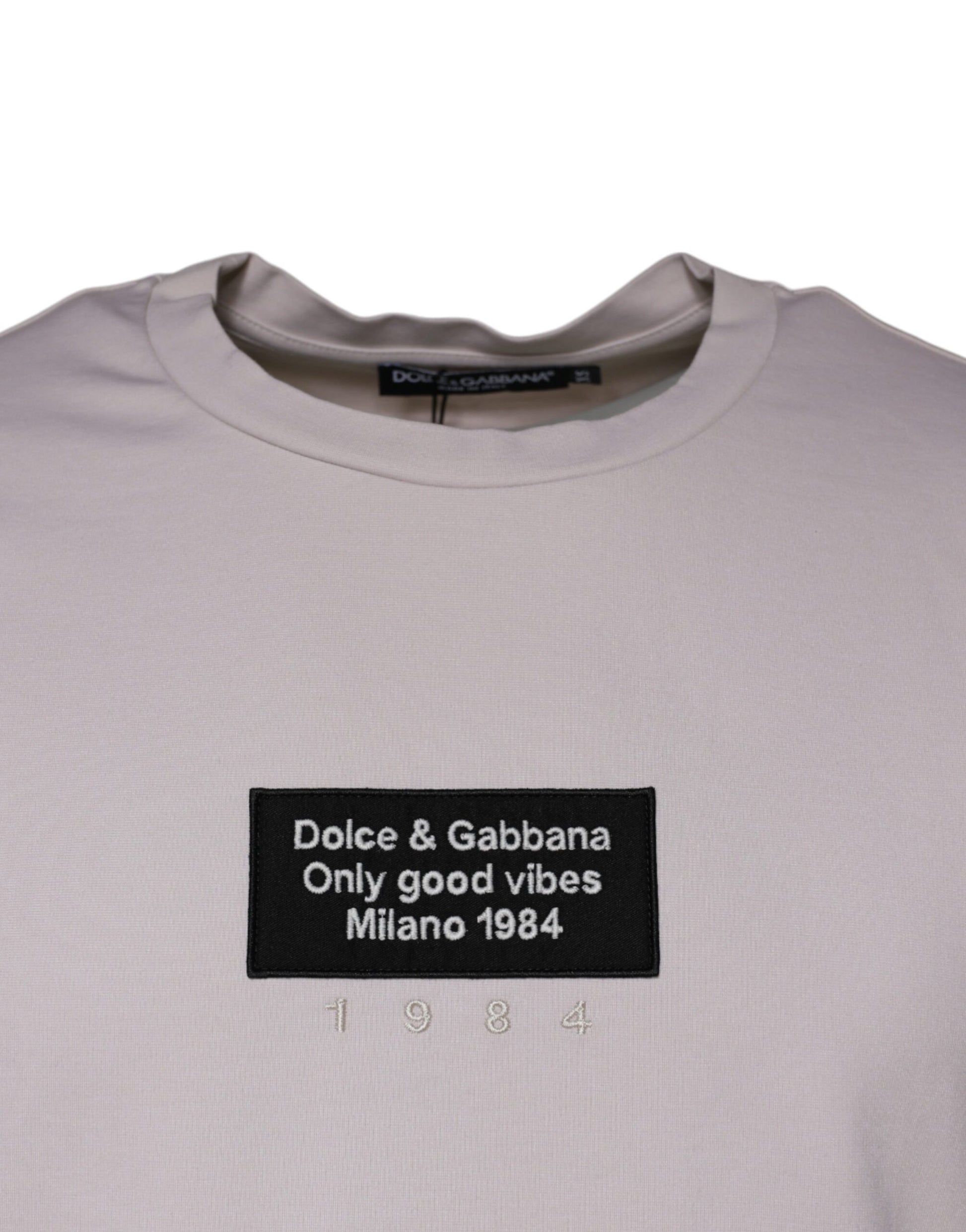 Tan t-shirt with black text and logo
