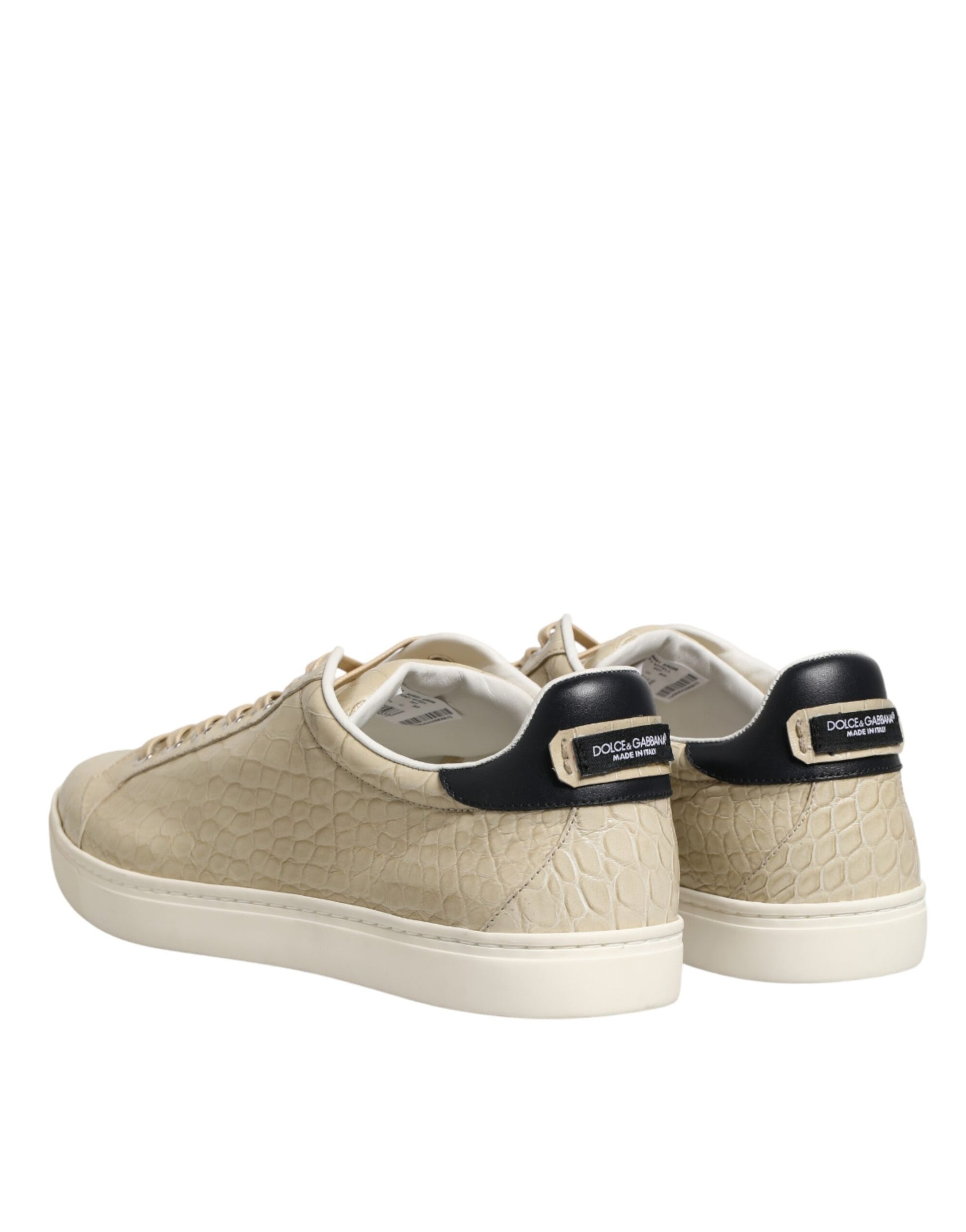 Tan sneakers with black laces and a gold buckle