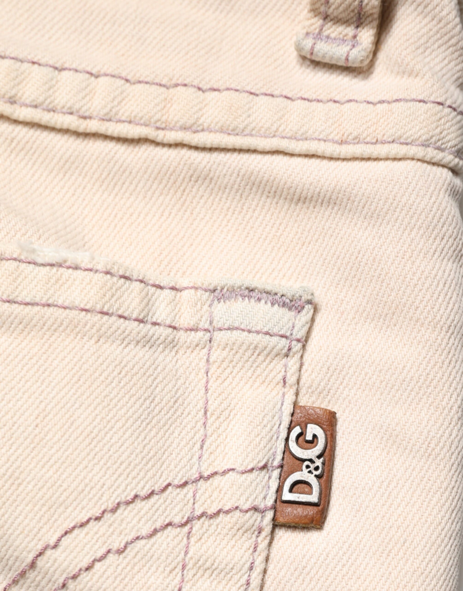 Pair of light beige jeans with a brown leather label on the right side