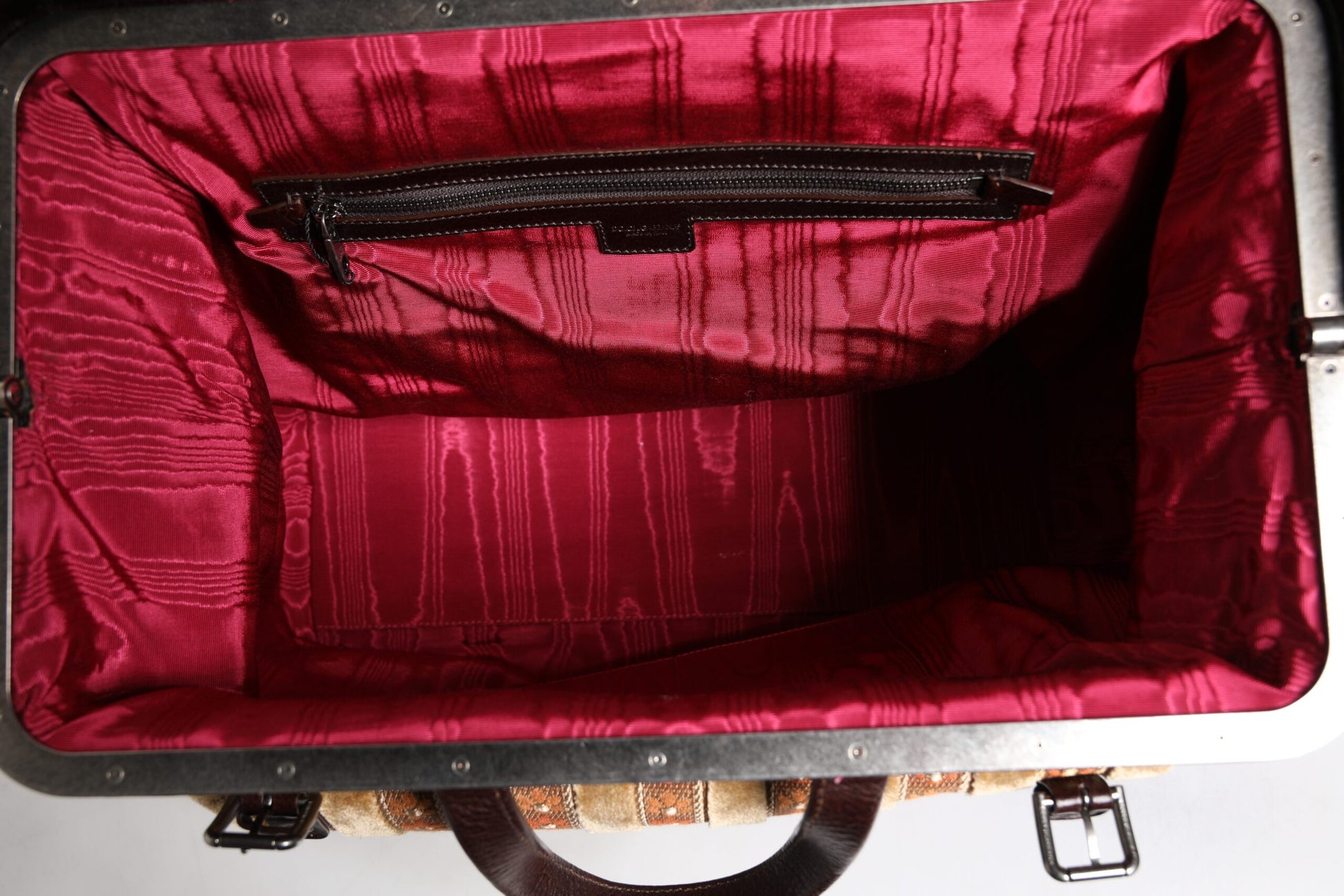 Red velvet lined suitcase with metal trim