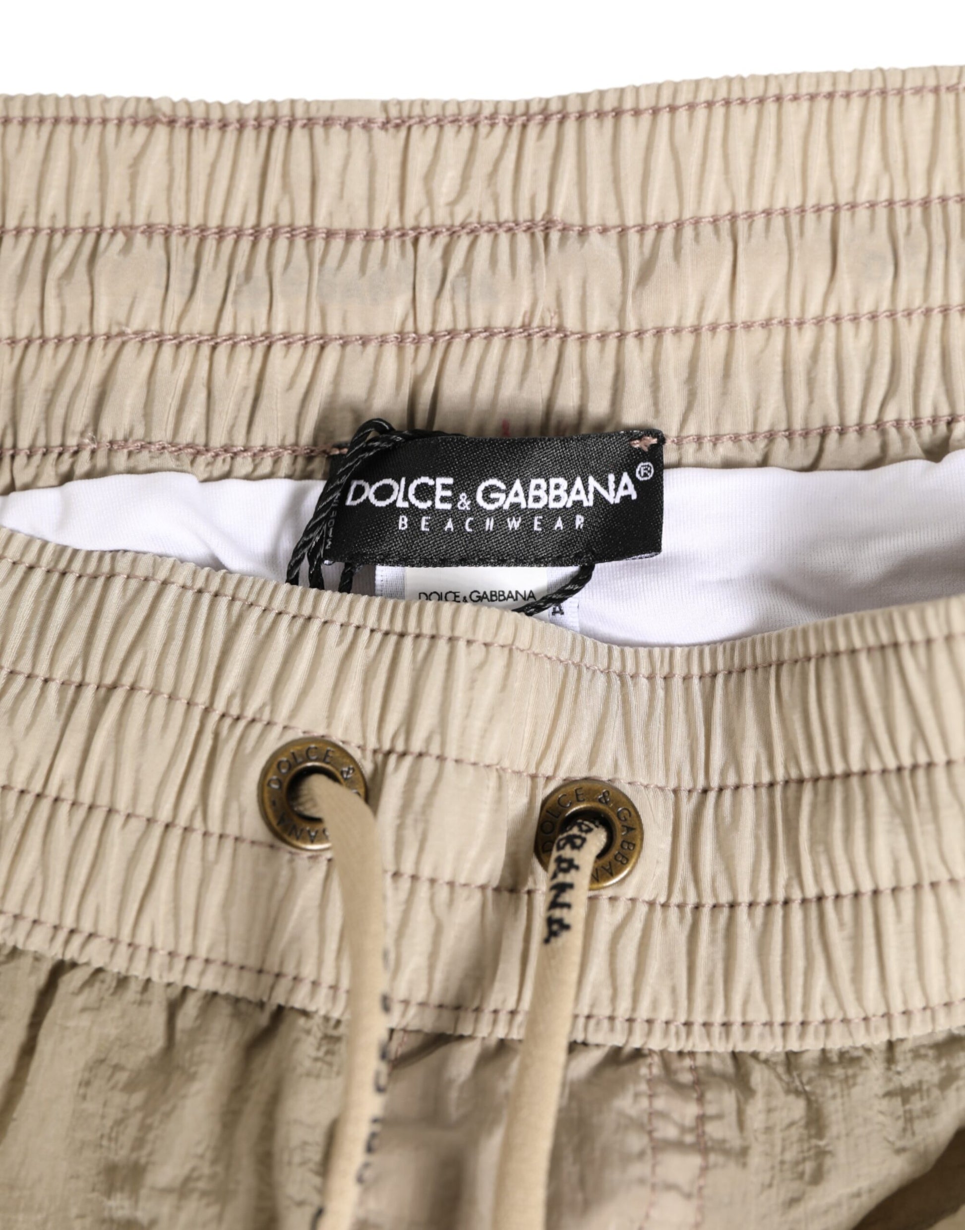 Pair of beige pants with ruffled hem and buttons