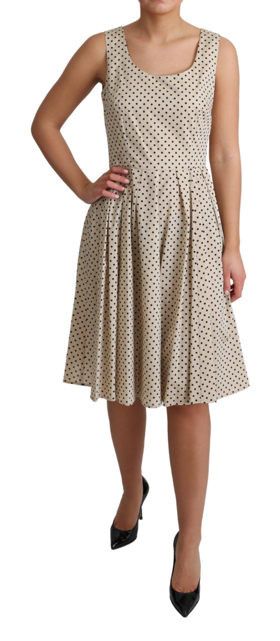 A beige polka dotted cotton A-line dress by Dolce & Gabbana