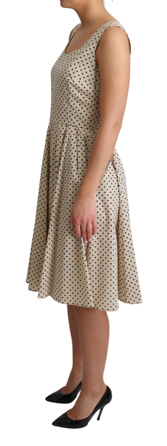 A beige polka dotted cotton dress with an a-line skirt