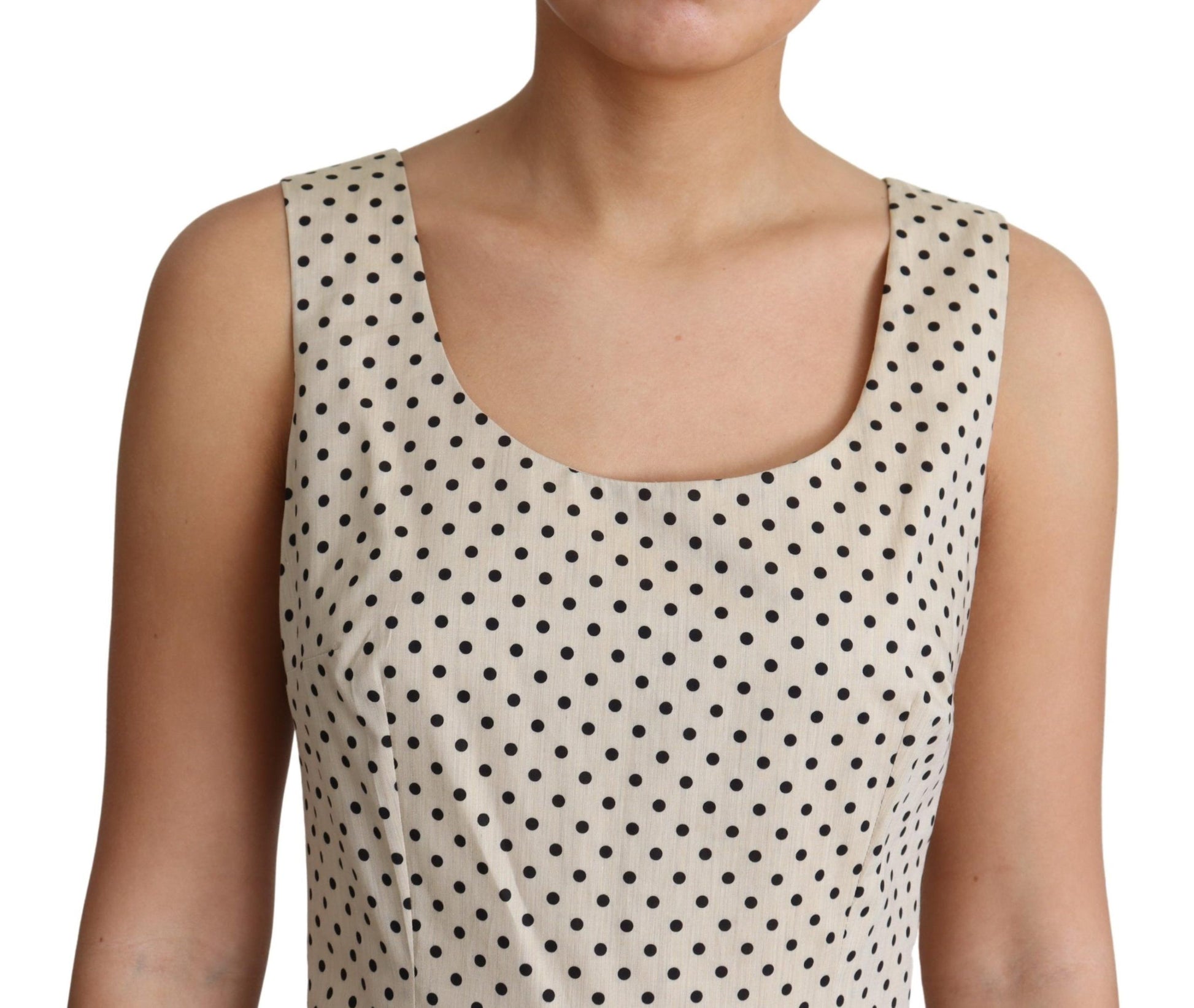 A beige polka dotted cotton dress with an A-line silhouette