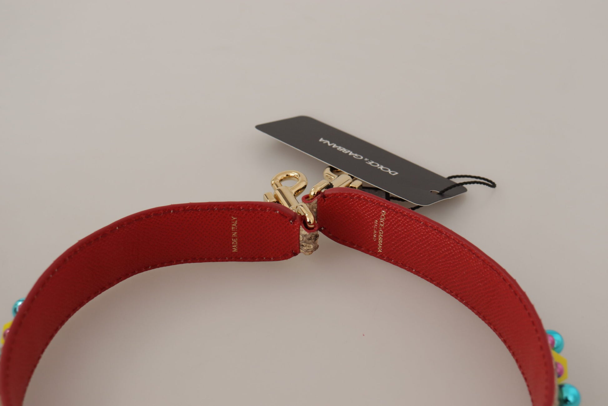 Red strap with gold buckle
