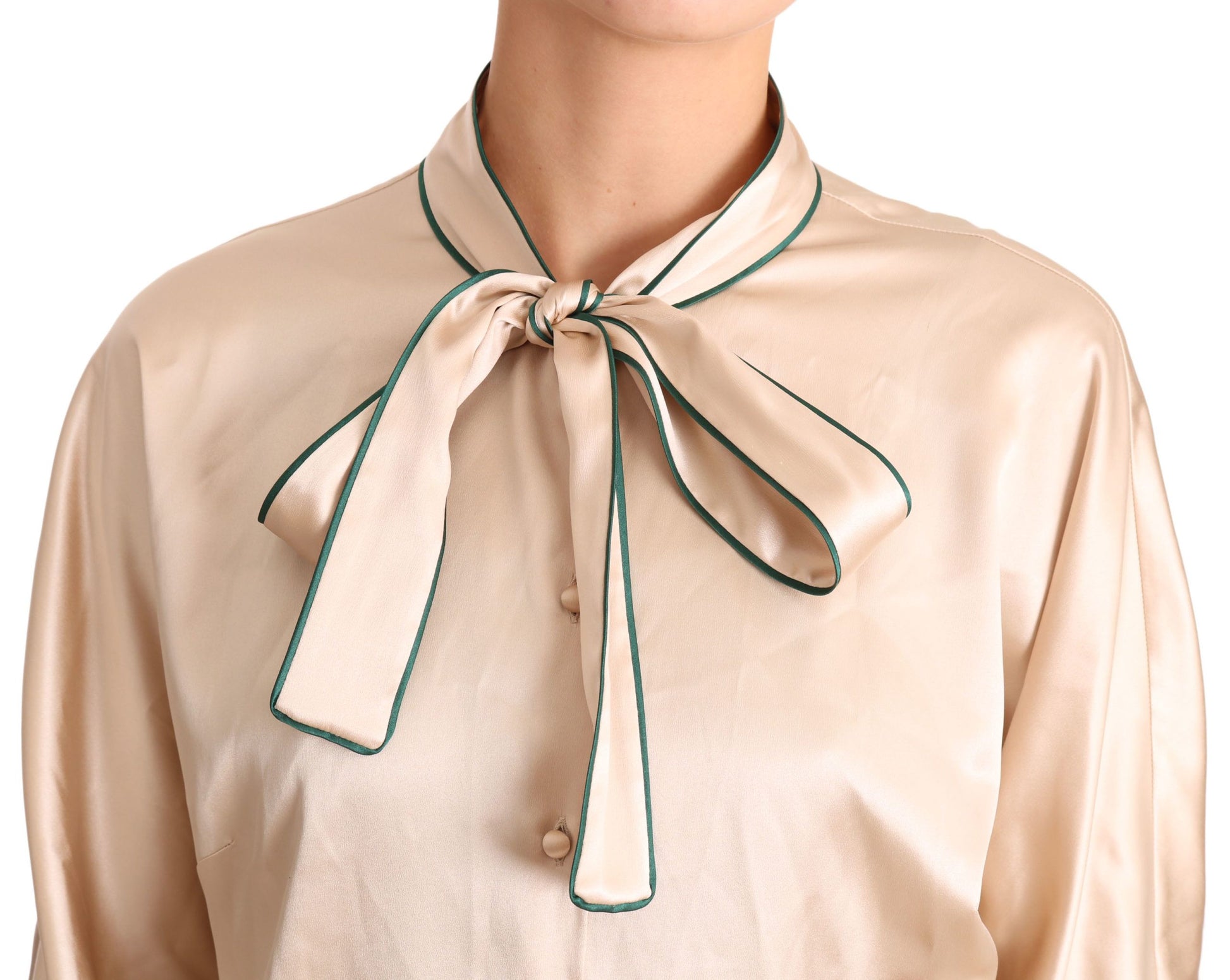 Woman's beige shirt with green bow tie