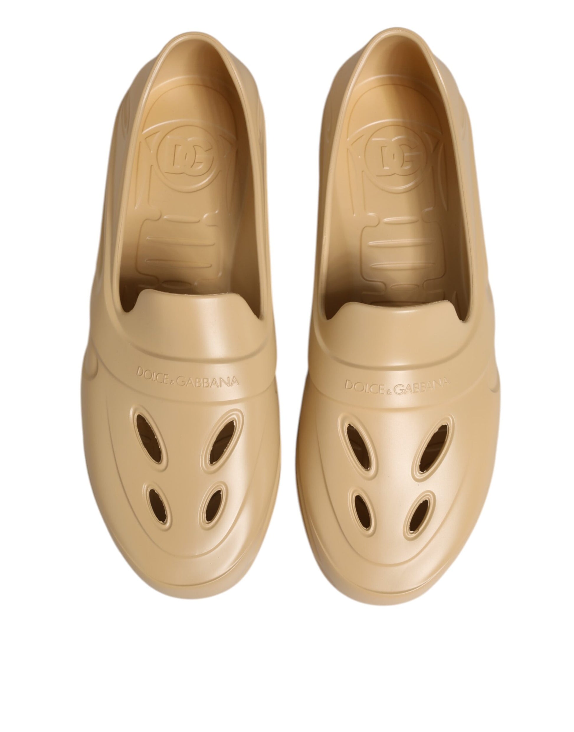 Pair of tan shoes with holes in soles