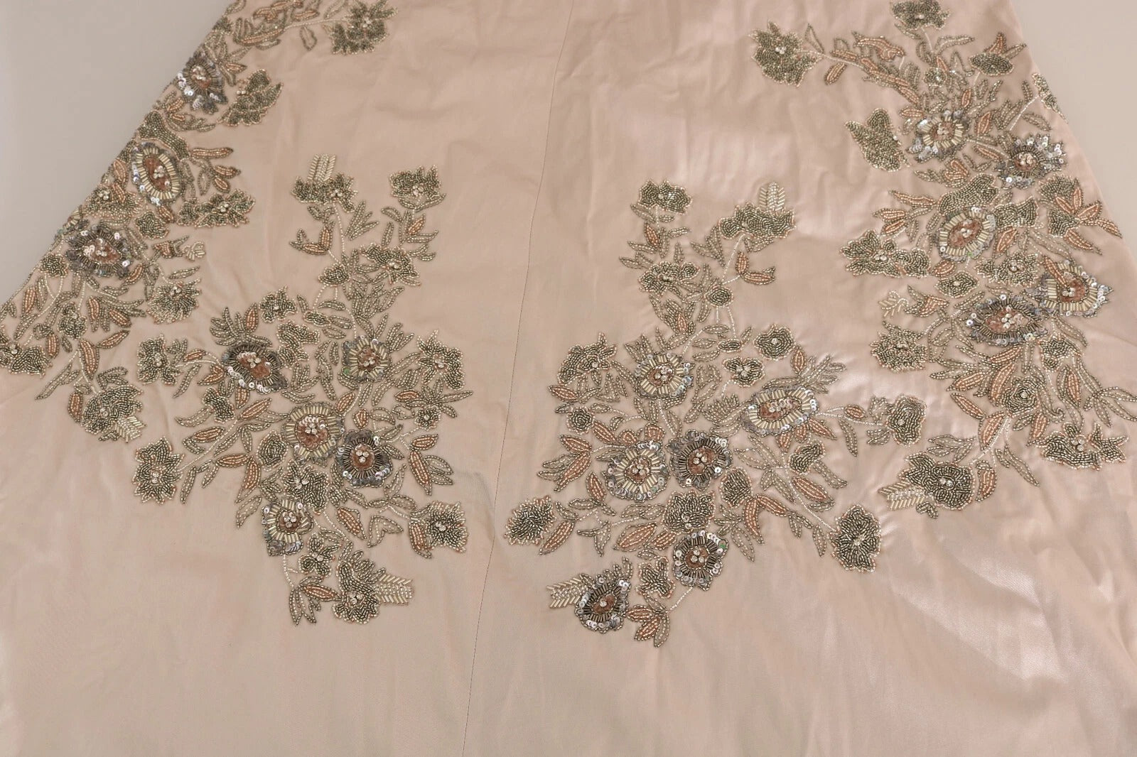 A beige sequined dress with floral embroidery and a flared skirt