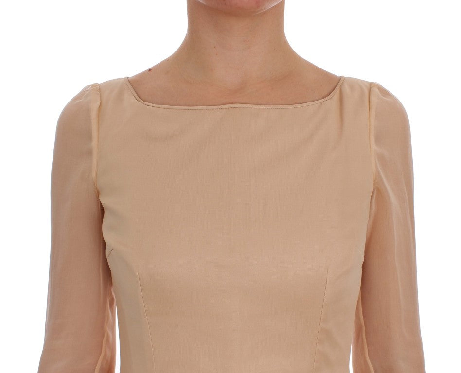 Tan sleeveless dress with fitted bodice and flared skirt
