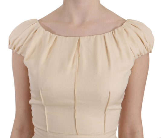A beige silk column cap sleeve gown dress with ruched detailing