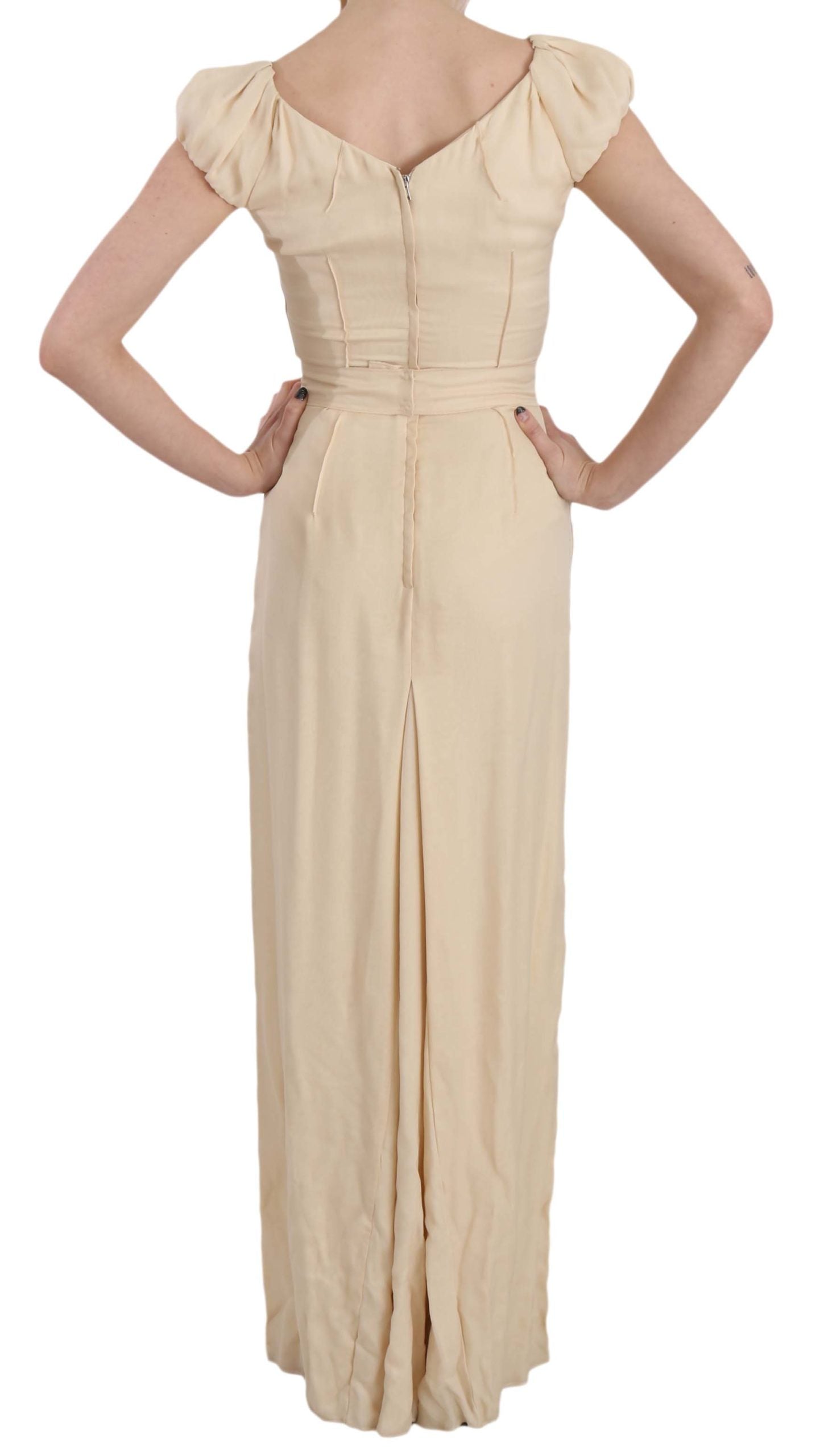 A beige silk column cap sleeve gown dress with a fitted bodice and flowing skirt