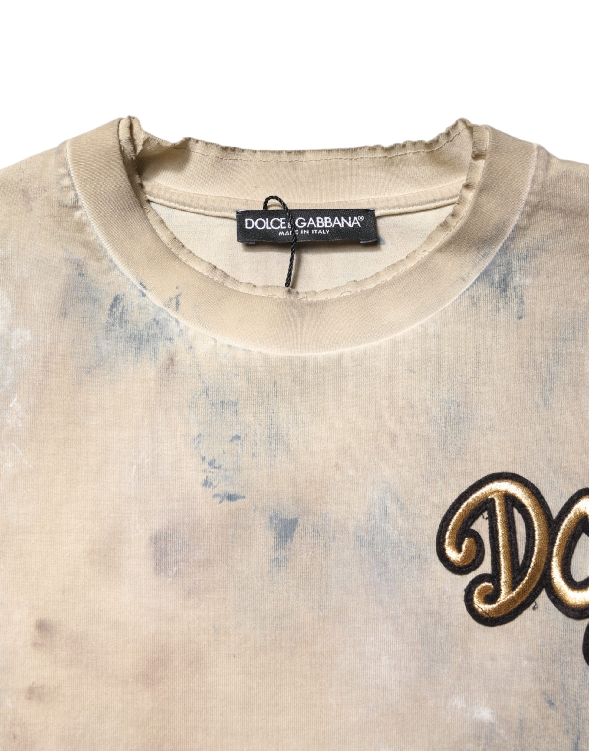 Tan sweater with gold lettering on front