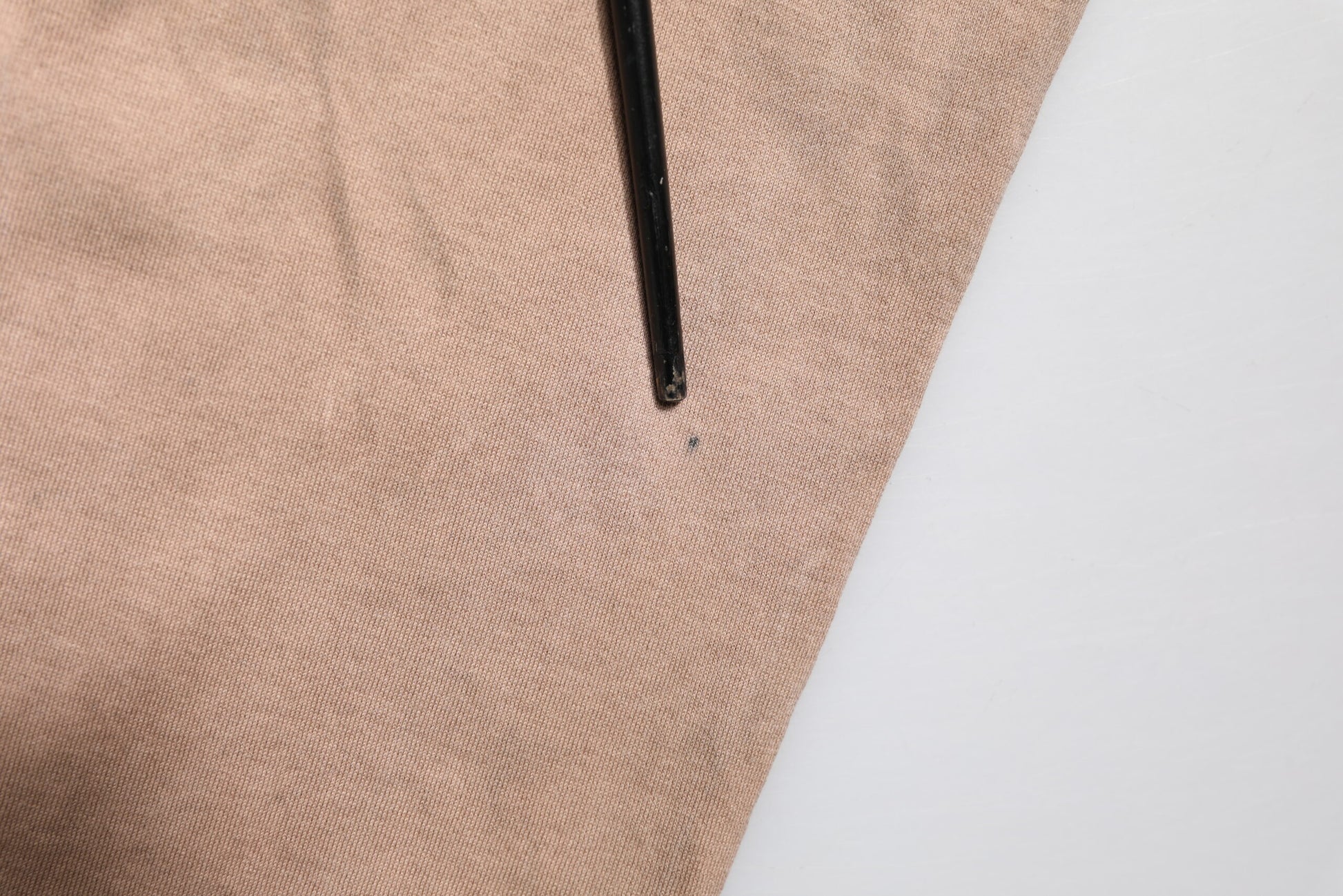 Brown fabric with black pen marking on it