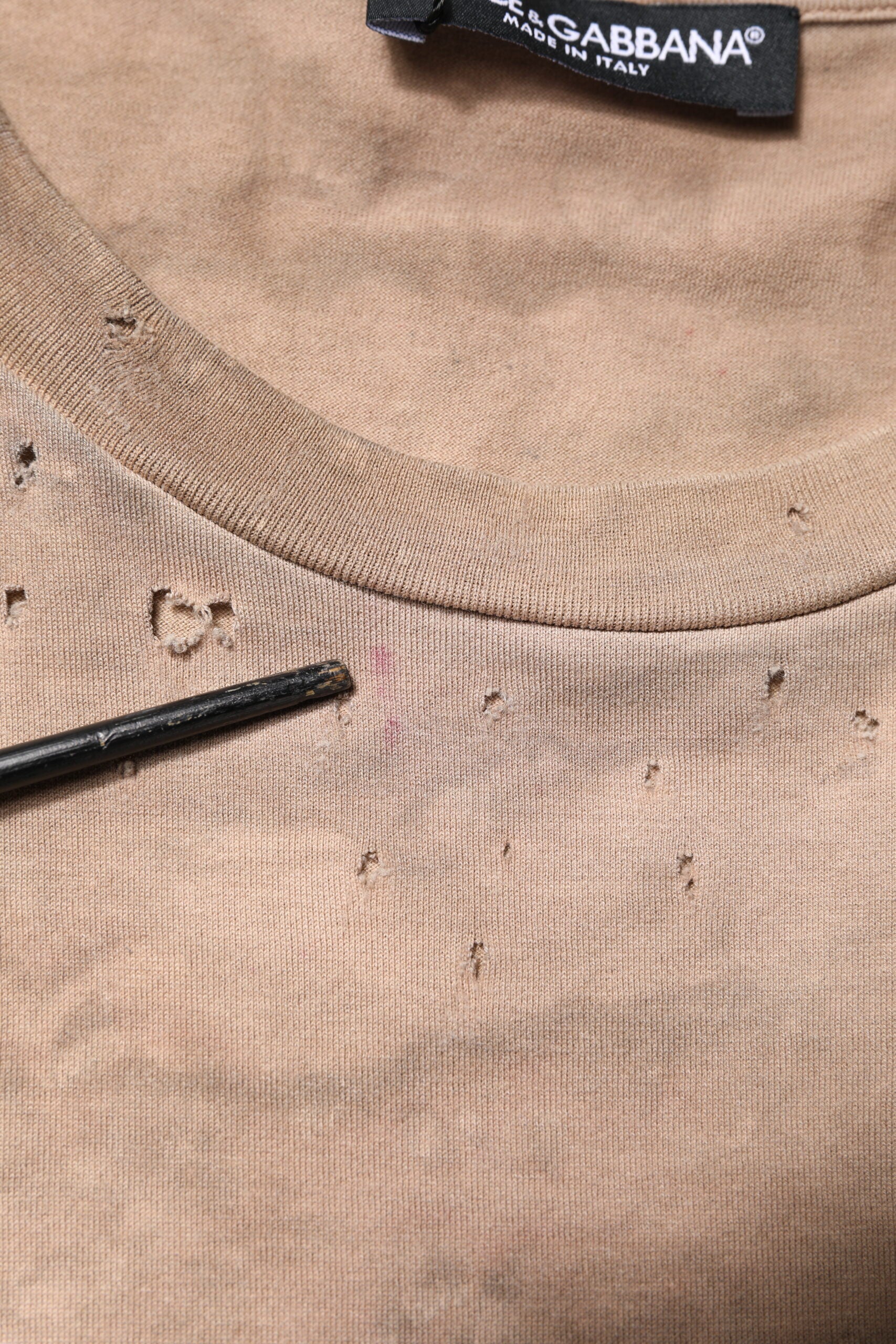 Brown sweater with holes in neckline