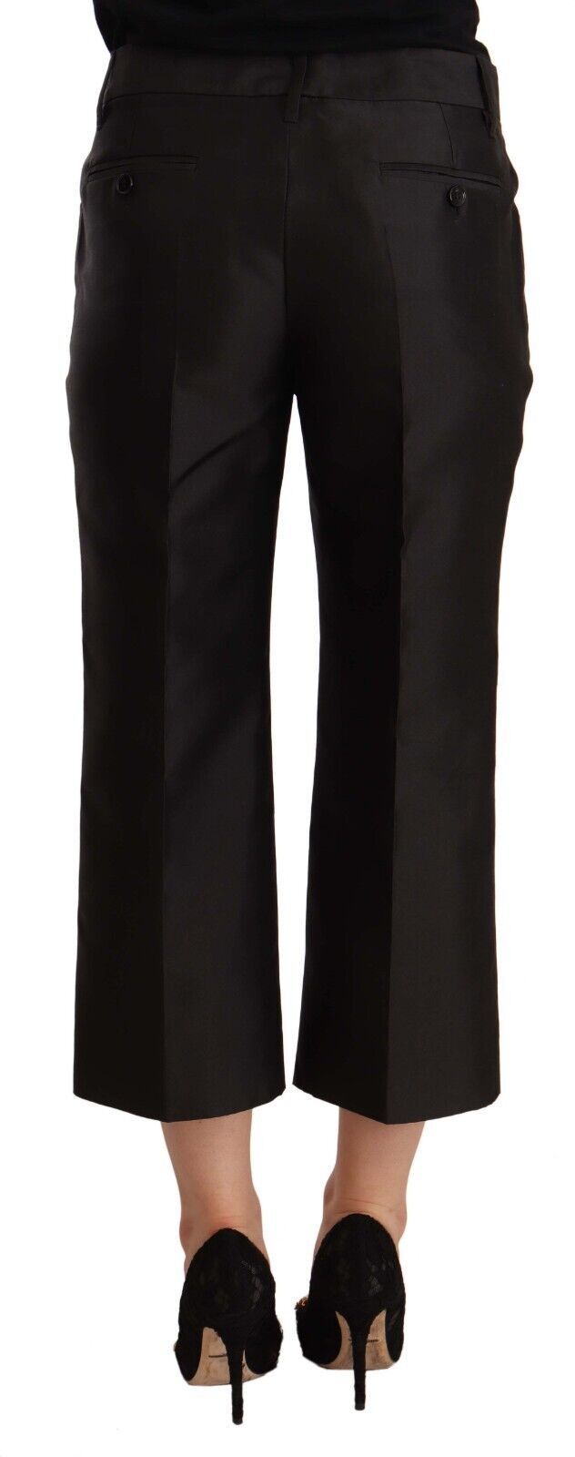 Pair of black trousers with rolled up legs