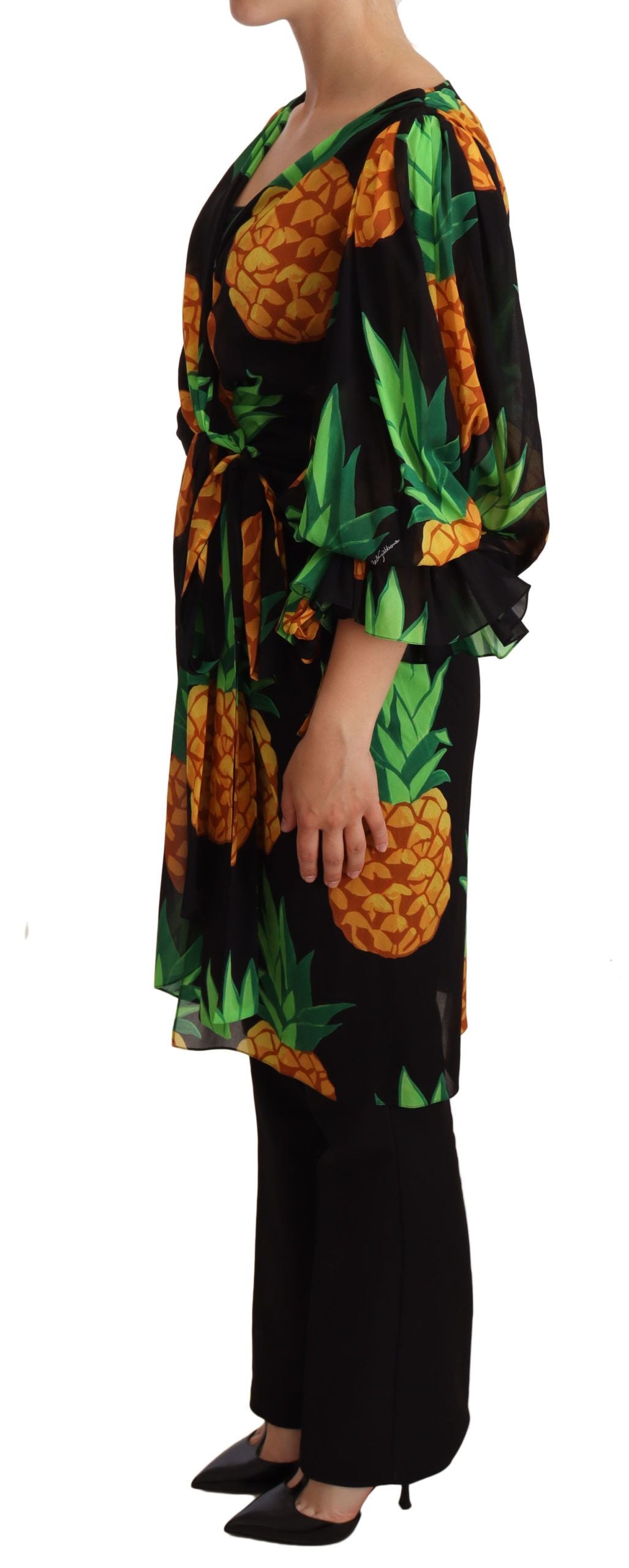 A black dress with a pineapple print, featuring a wrap style and stretch silk material