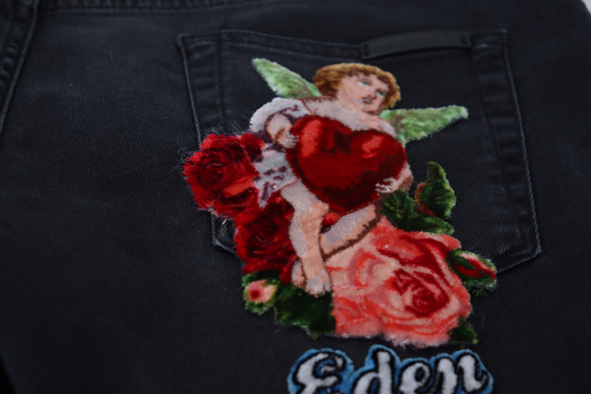 Embroidered angel on denim jeans