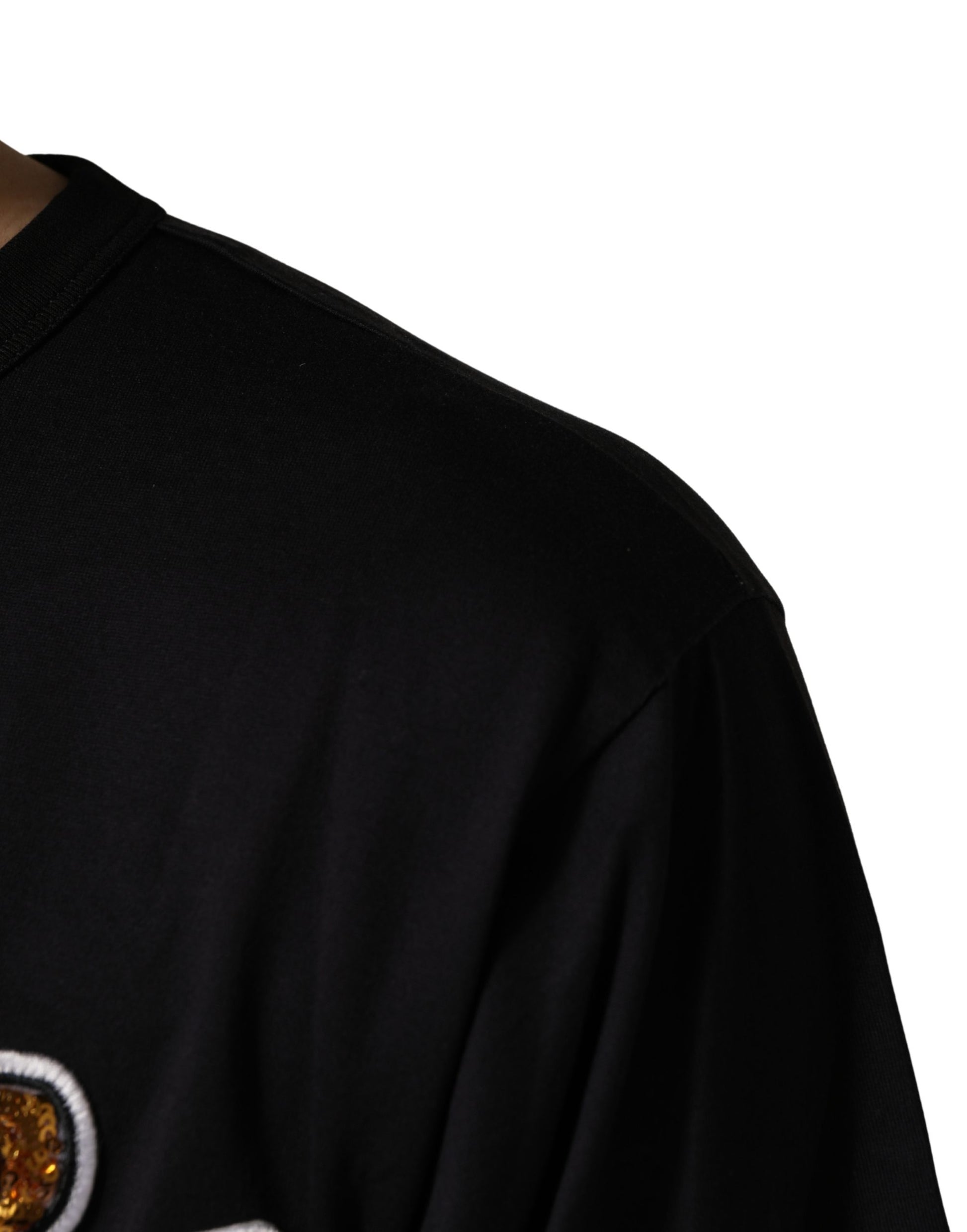 A black crew neck t-shirt with an angel print on the front