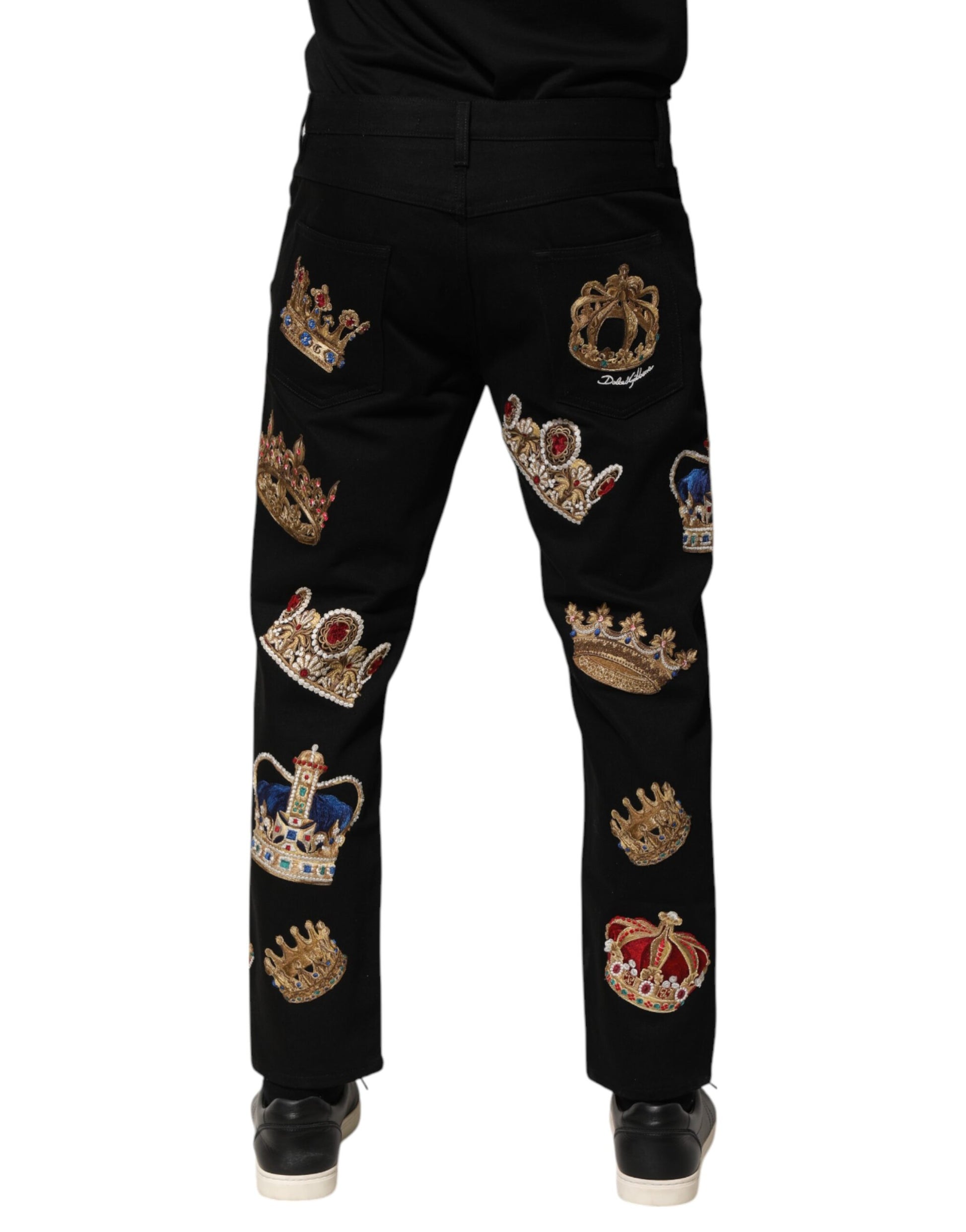 Black trousers with royal crowns embroidered on them