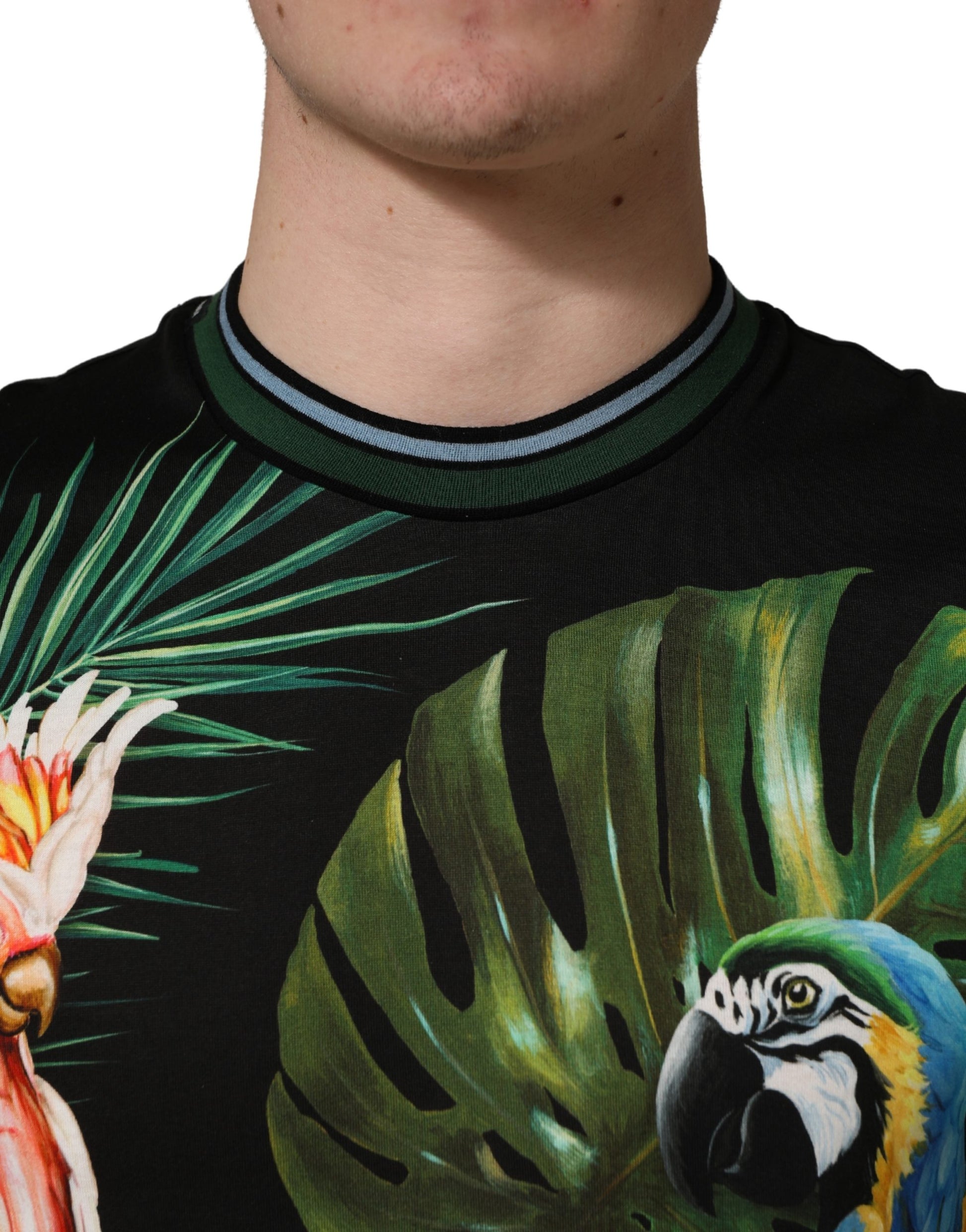 Man wearing a colorful shirt with tropical birds on it