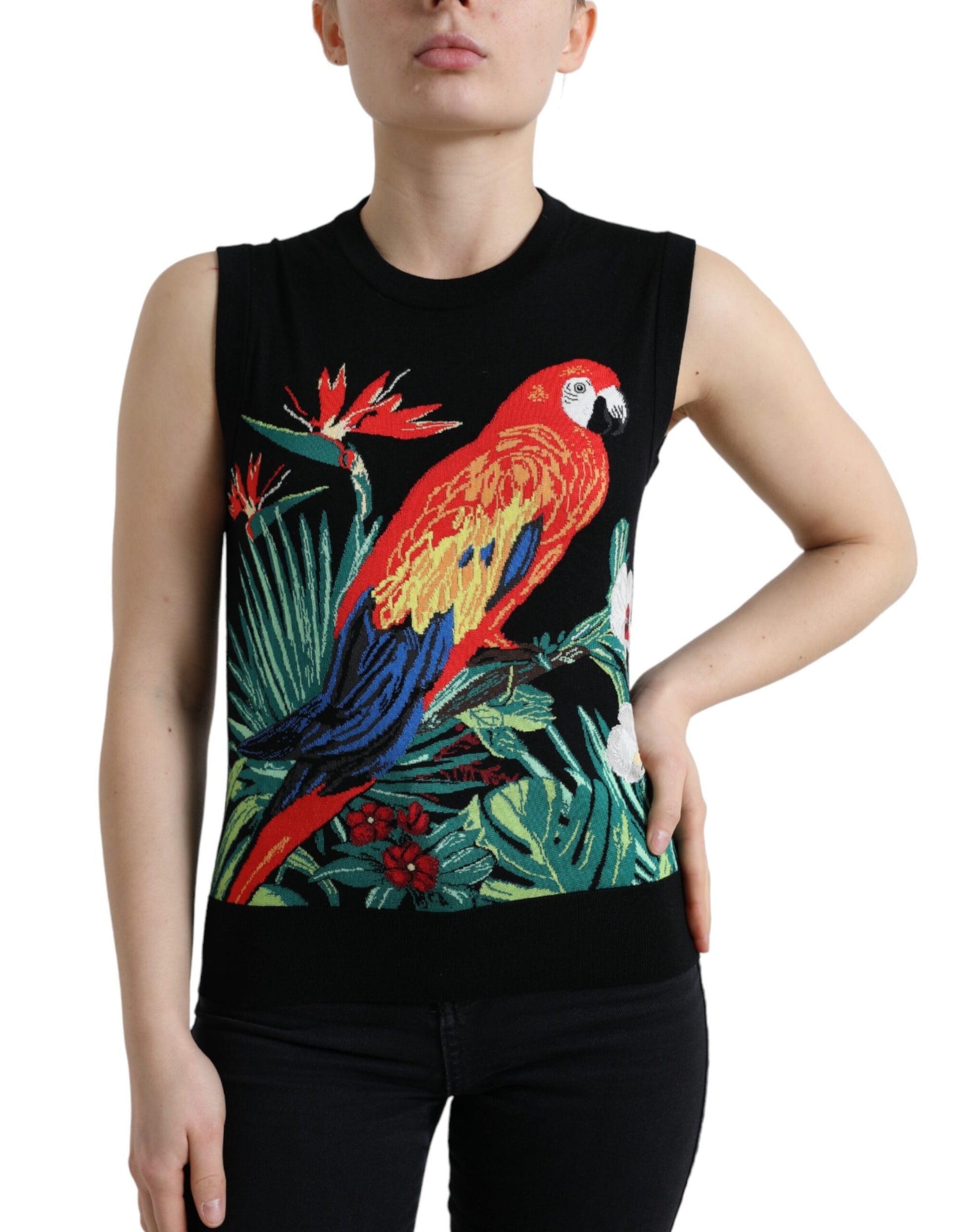 Woman wearing a black tank top with a colorful parrot design