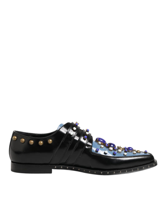A pair of black dress shoes with blue embellishments and gold studs