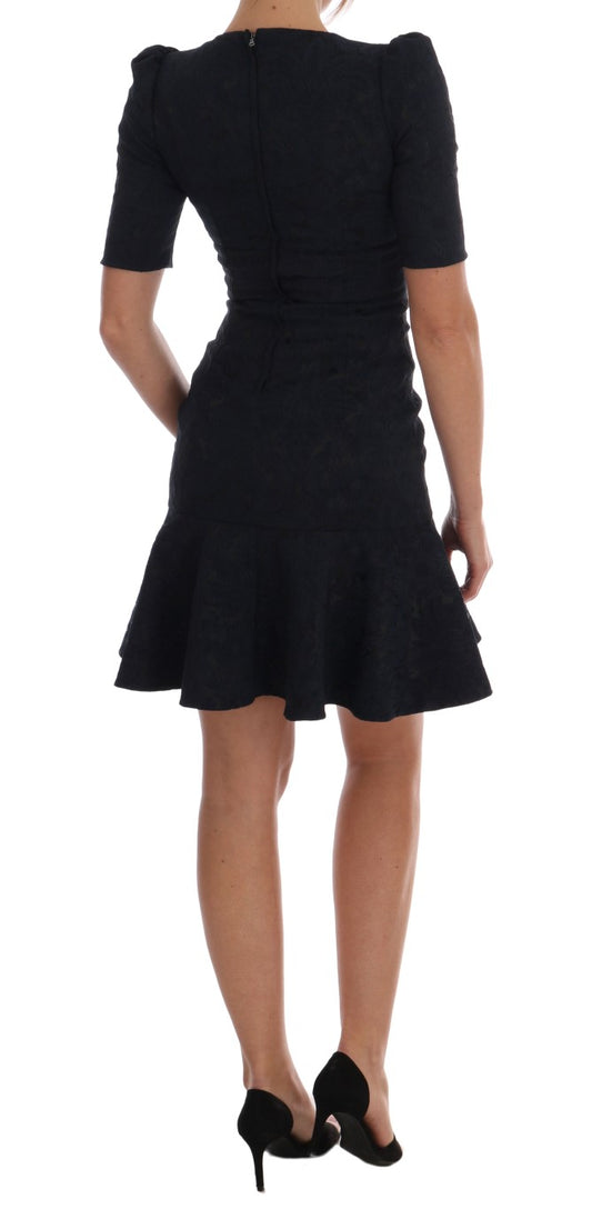 A black dress with blue flared sleeves, worn by a mannequin
