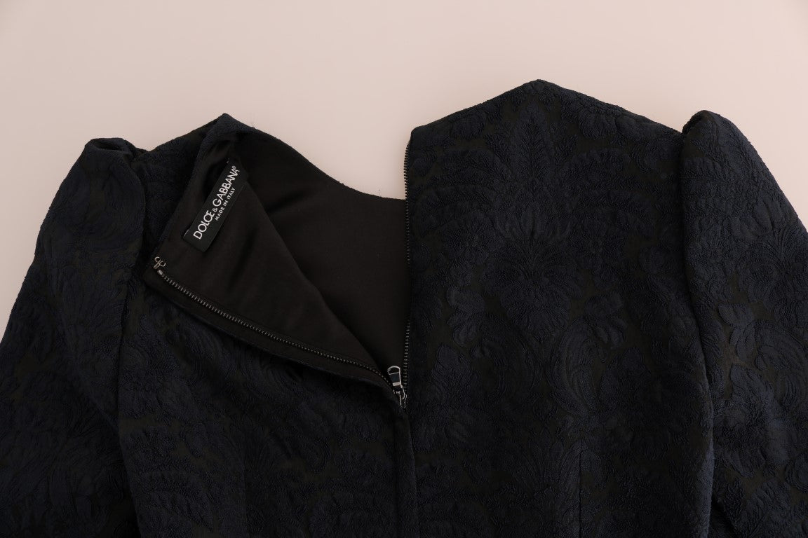 A black dress with a blue flare design, featuring a zippered front and a brand logo on the chest