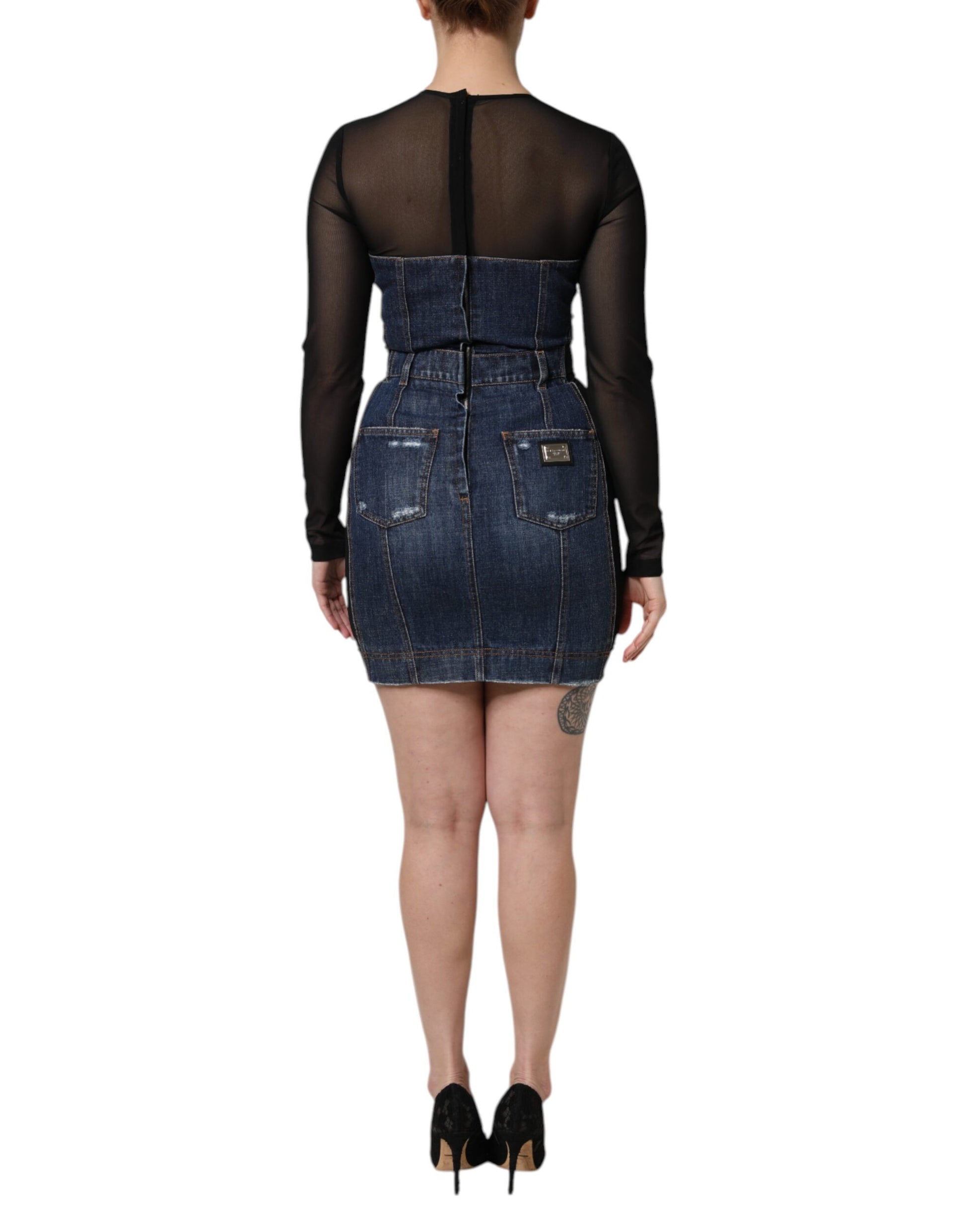 A black denim mini dress with long sleeves and a high waist, featuring a lace-up back detail