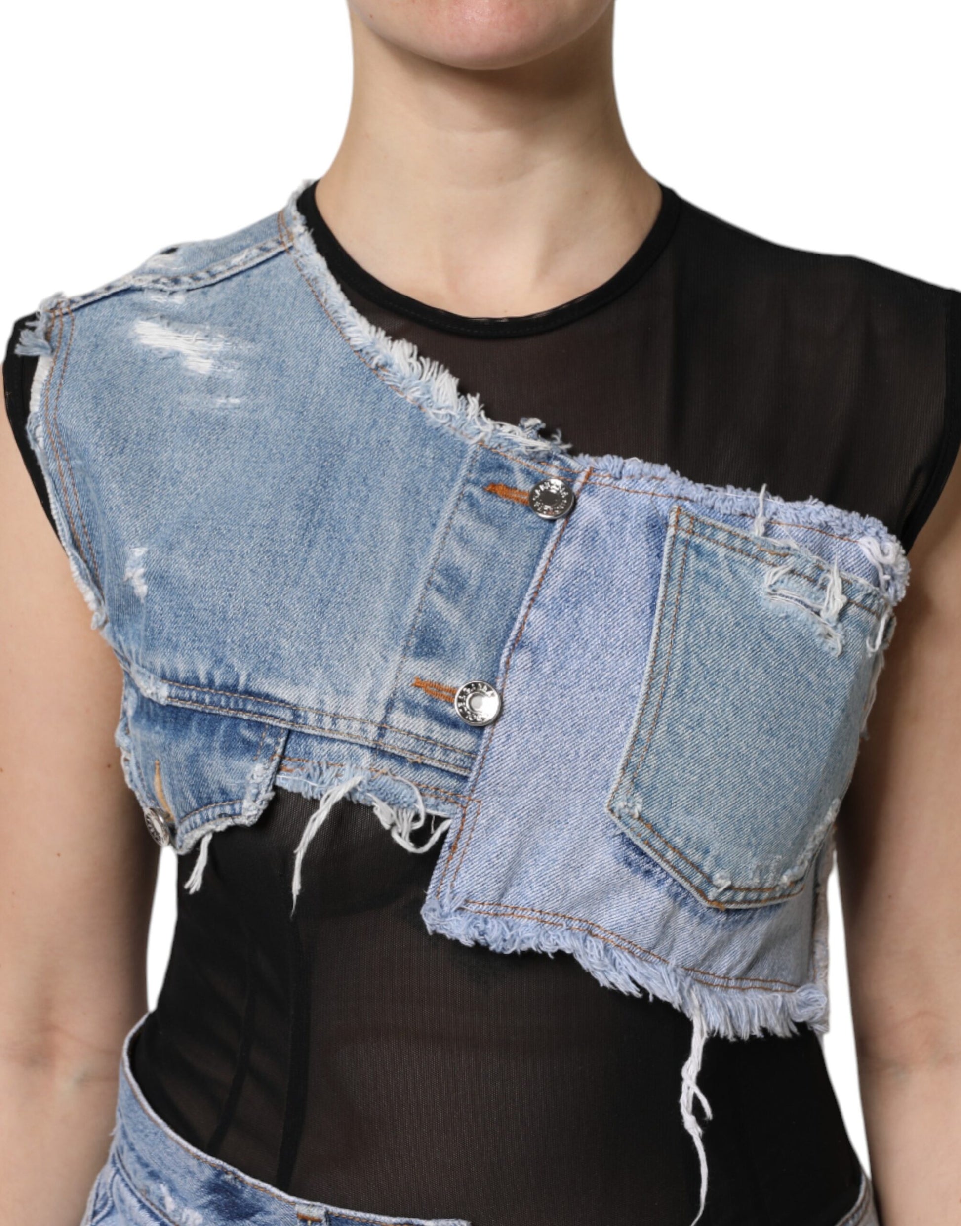 A sleeveless denim mini dress with black and blue panels, worn by a model