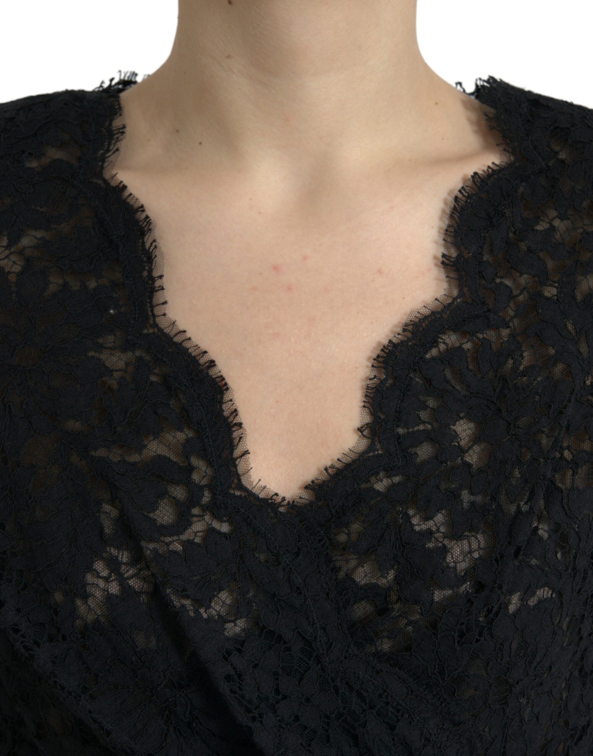A black lace sheath dress with a deep neckline and short sleeves