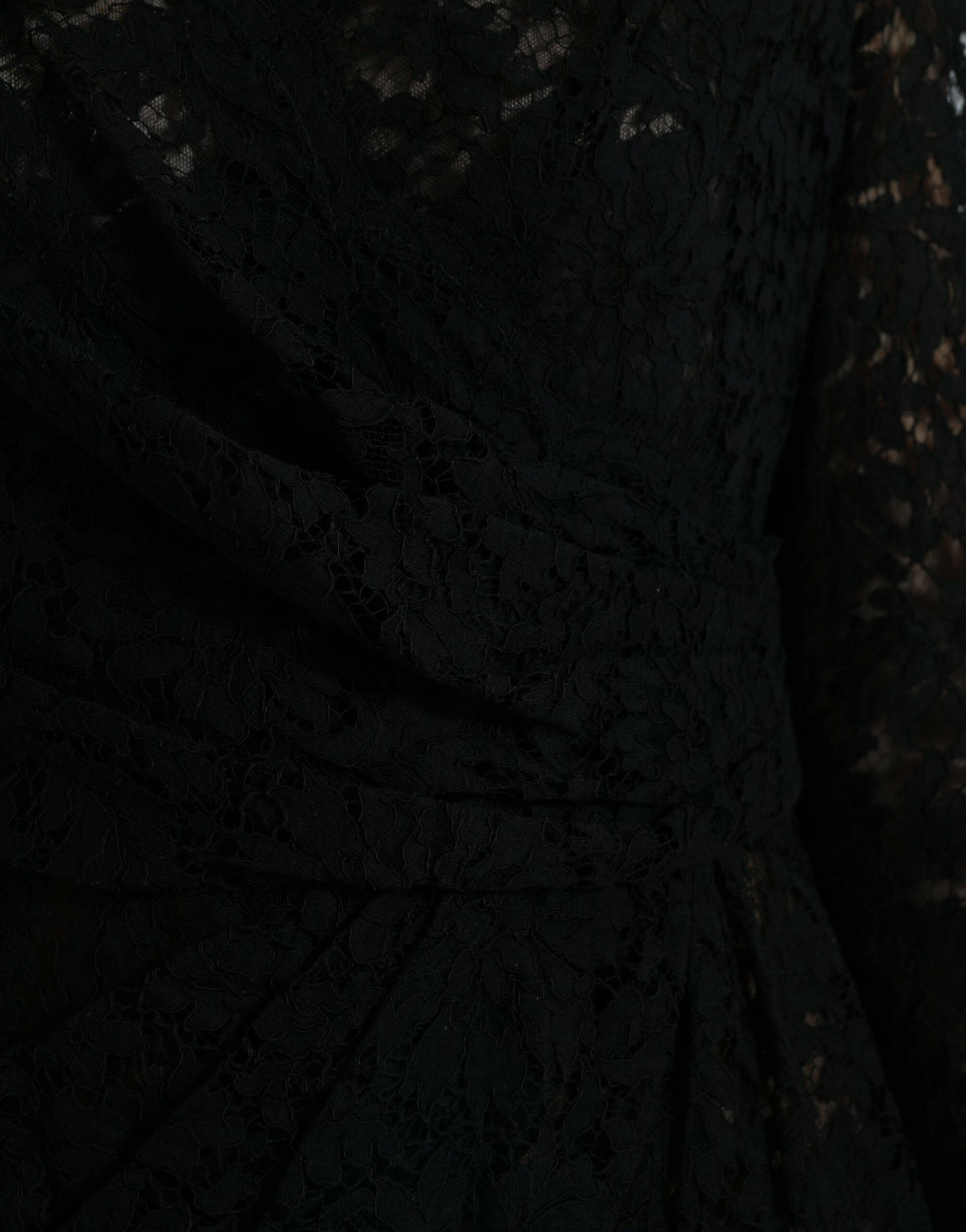 A black lace bodycon dress with a sheath silhouette, featuring intricate lace detailing