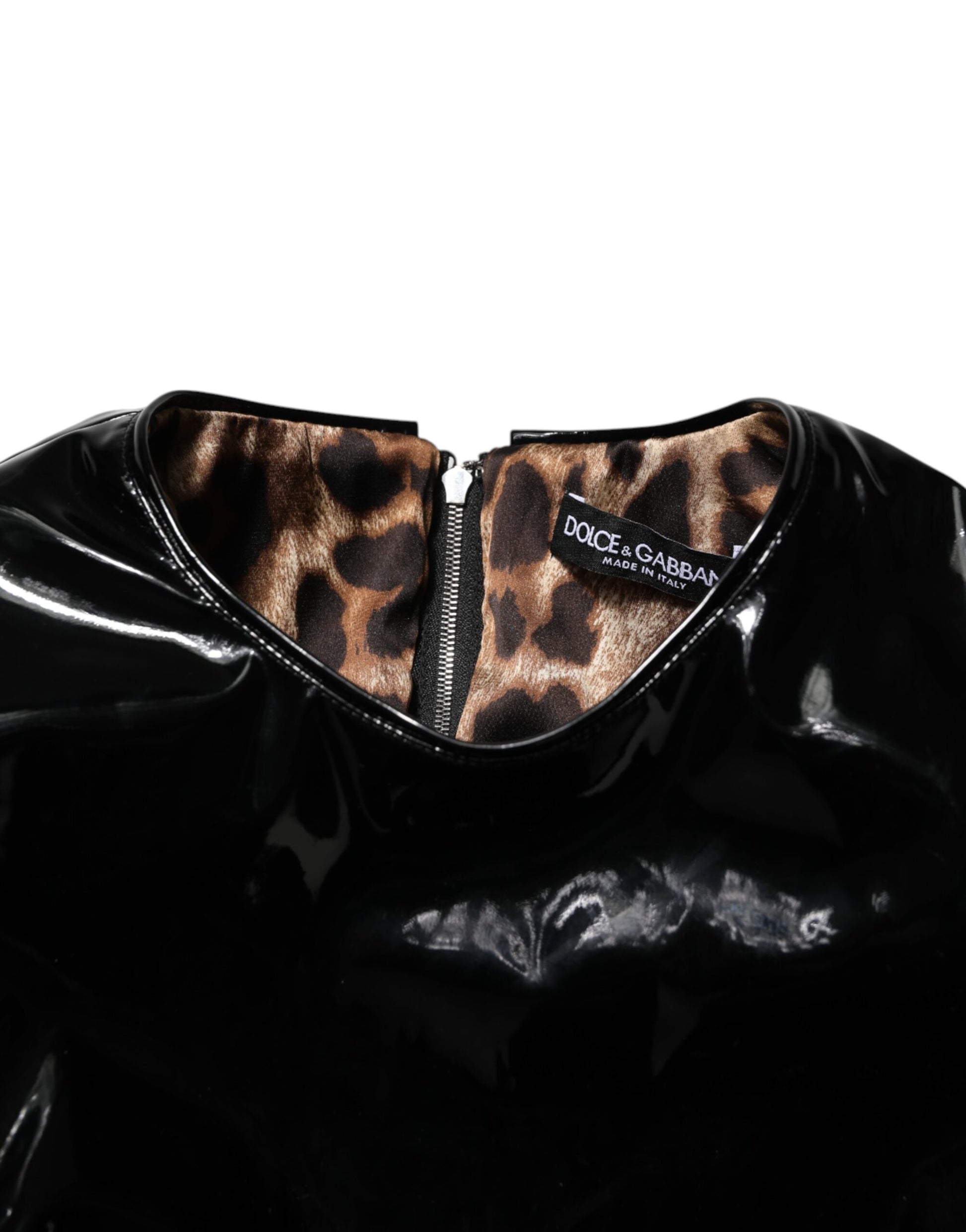 A black bodycon sheath dress with puff sleeves and a zipper in the front