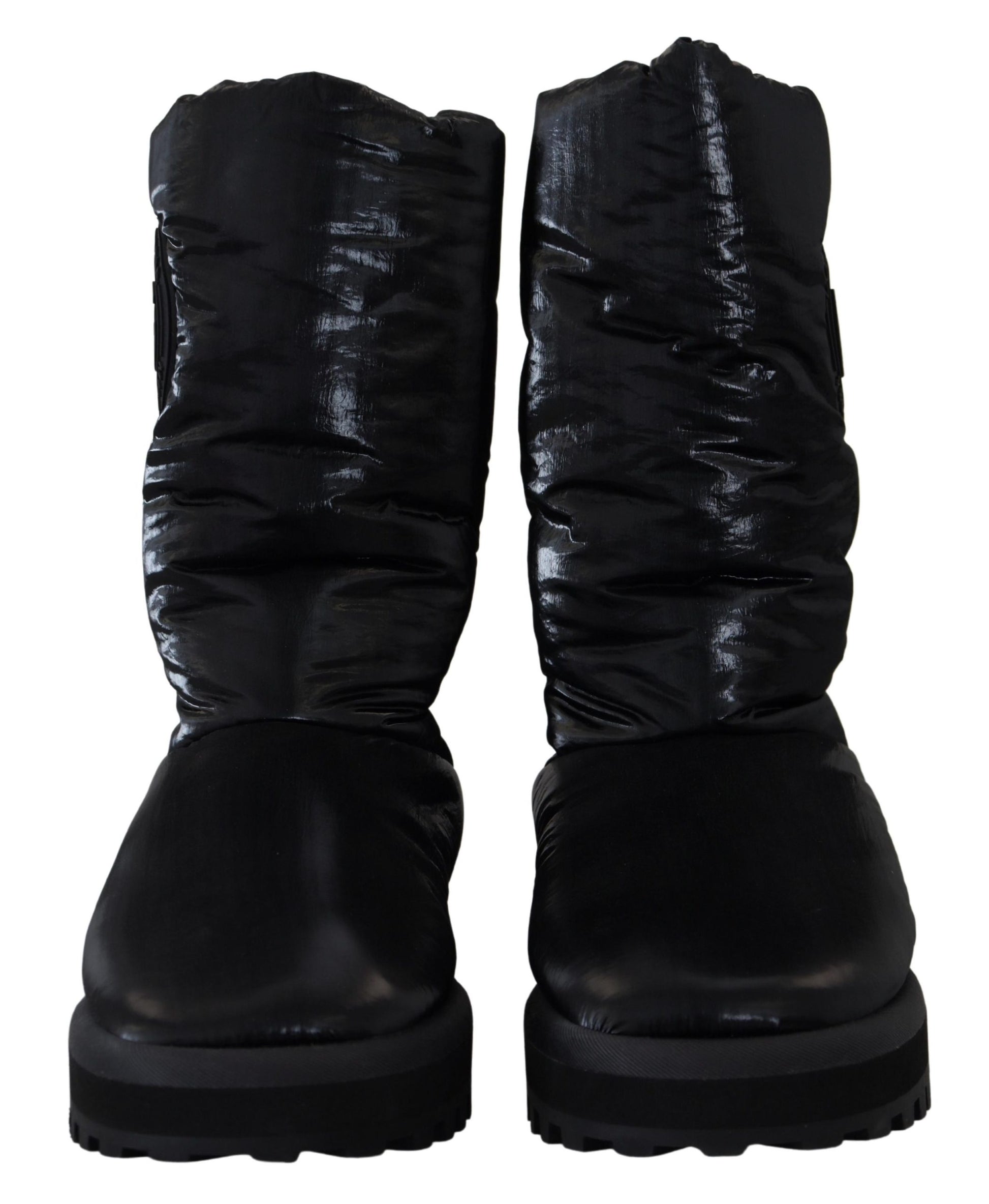 Pair of black boots with laces and a shiny surface