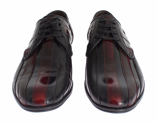 Pair of black leather dress shoes with red accents, laces and soles