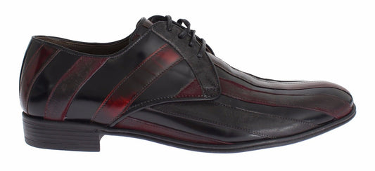 A pair of black leather dress shoes with red accents, featuring a lace-up design and a low heel